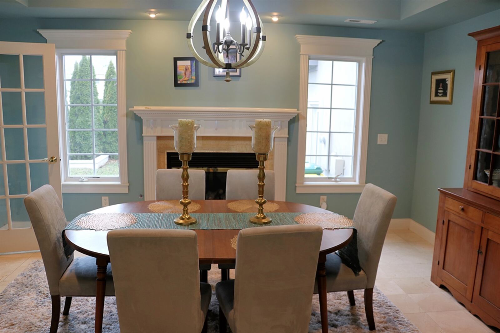 A French door opens from the kitchen into the formal dining room, which has a fireplace with wood mantel. 