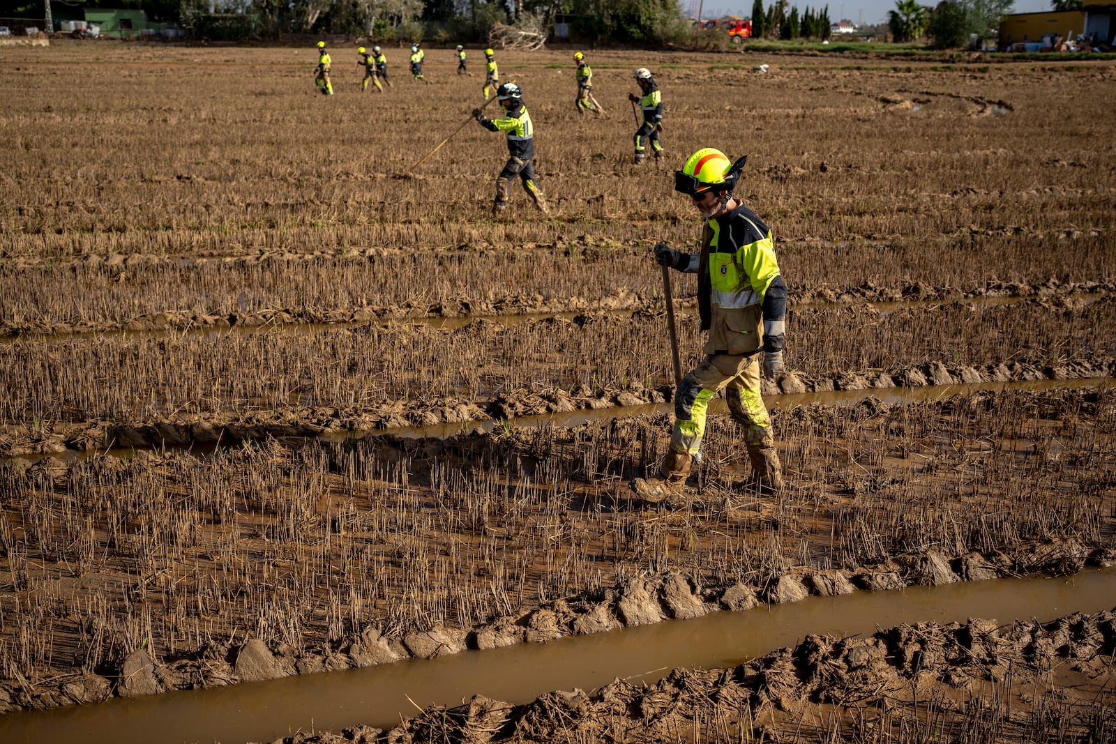 Members of the fire brigade search the area for bodies washed away by the floods in the outskirts of Valencia, Spain, Friday, Nov. 8, 2024. (AP Photo/Emilio Morenatti)