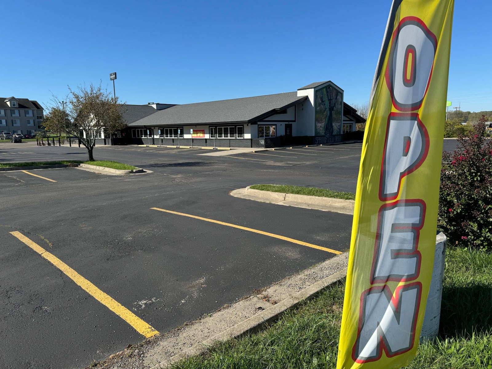 An ``OPEN'' banner waves in the wind outside Mango's Lounge, but the door is chained shut. Thursday, October 10, 2024 Bill Lackey/Staff