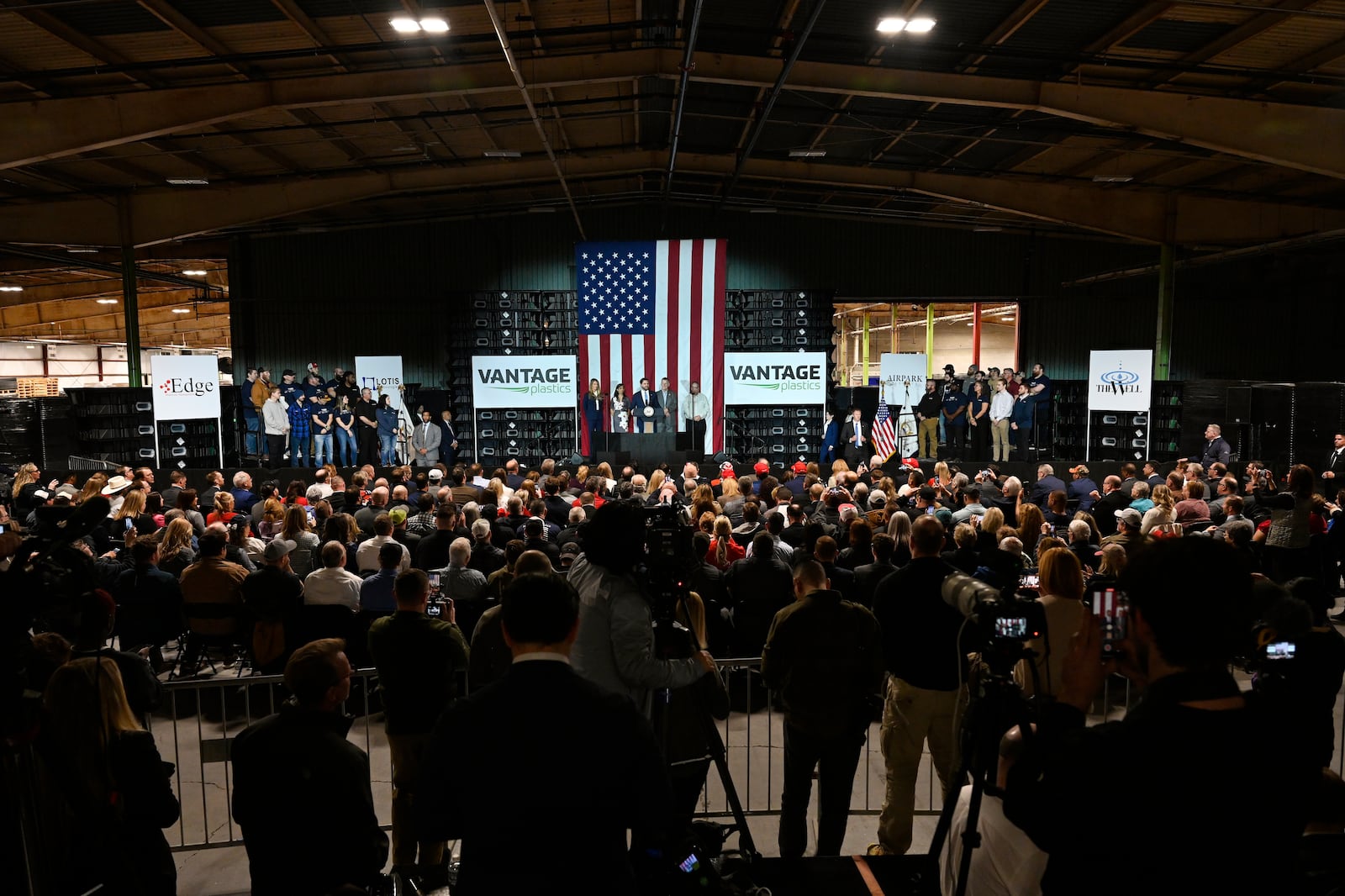 Vice President JD Vance, center stage, speaks at a rally about "America's industrial resurgence," Friday, March 14, 2025, at Vantage Plastics in Bay City, Mich. (AP Photo/Jose Juarez)