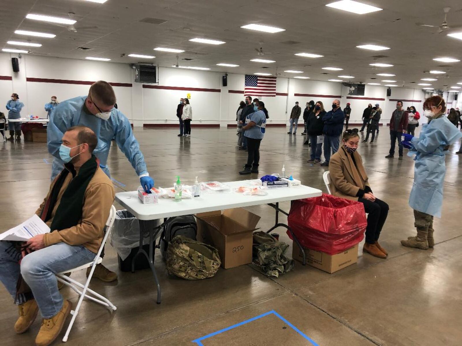 Curtis Lemon, left, and wife Abigail Stogdale arrived here on Friday from London, England and got tested at Sunday's COVID-19 clinic in order to safely visit his grandparents during the couple's two-month visit here. Photo by Brett Turner