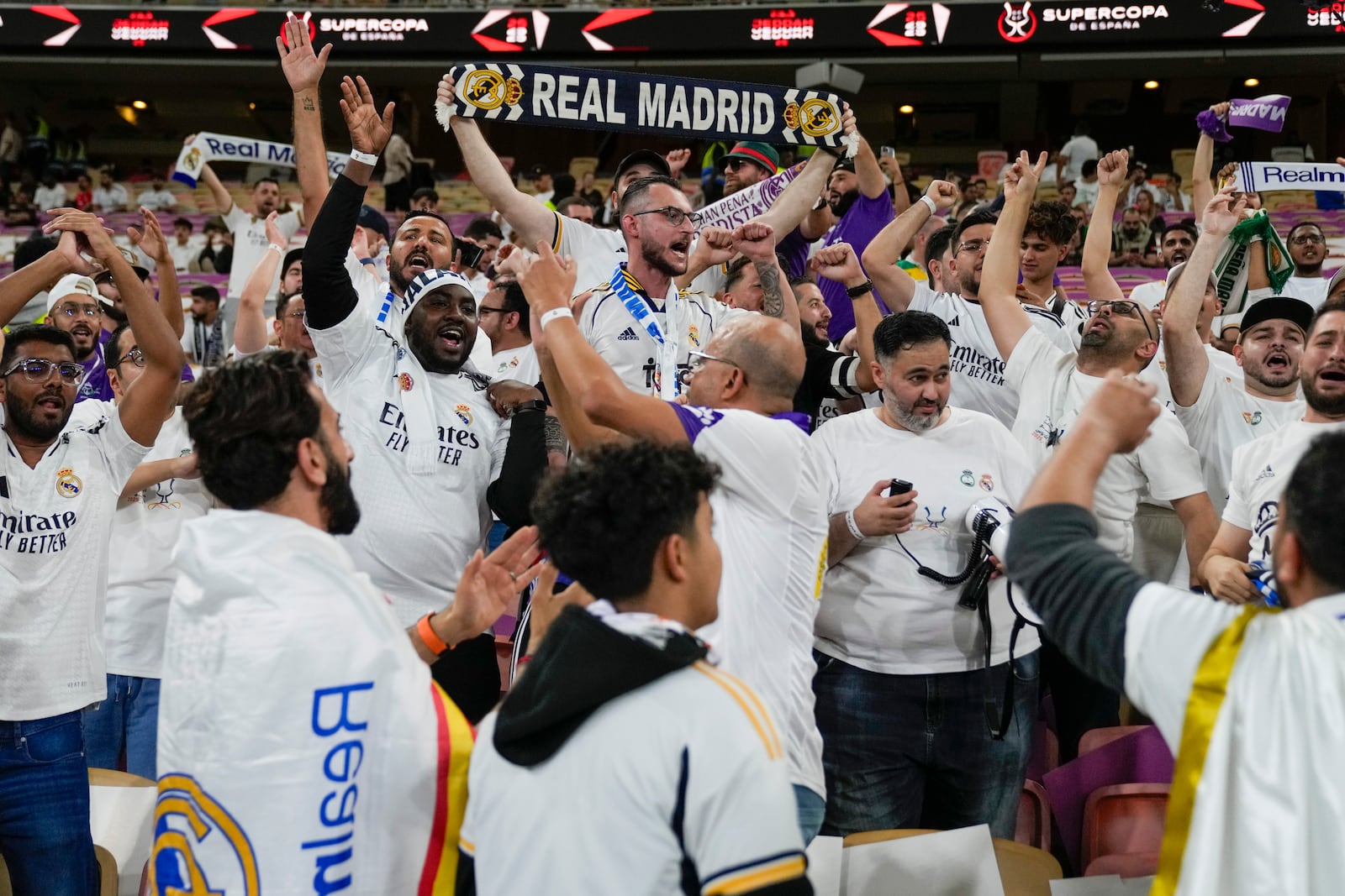 Supporters cheer ahead of the Spanish Super Cup semifinal soccer match between Real Madrid and Mallorca at the King Abdullah Stadium in Jeddah, Saudi Arabia, Thursday, Jan. 9, 2025. (AP Photo/Altaf Qadri)