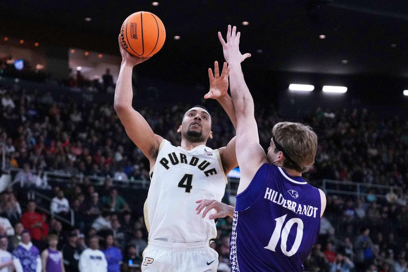 Purdue forward Trey Kaufman-Renn (4) drives to the basket against High Point forward Simon Hildebrandt (10) during the first half in the first round of the NCAA college basketball tournament, Thursday, March 20, 2025, in Providence, R.I. (AP Photo/Charles Krupa)