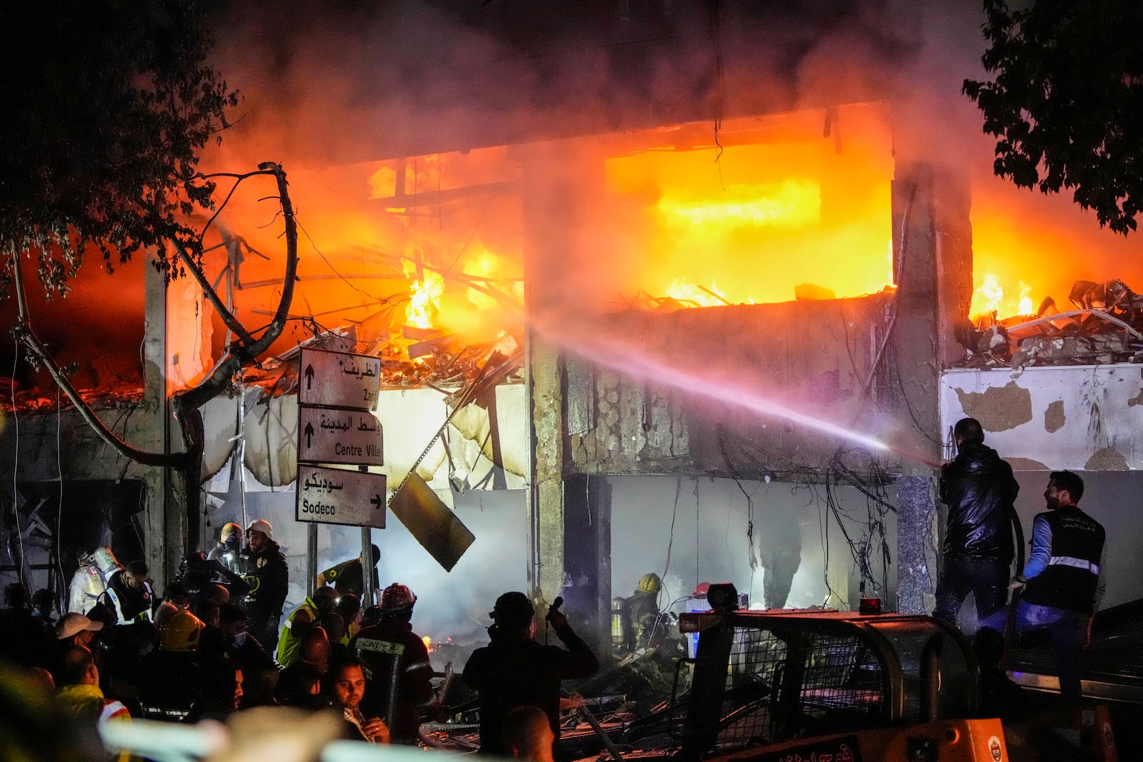 Civil defense workers extinguish a fire from the site of an Israeli airstrike in Beirut, Sunday, Nov. 17, 2024. (AP Photo/Hassan Ammar)