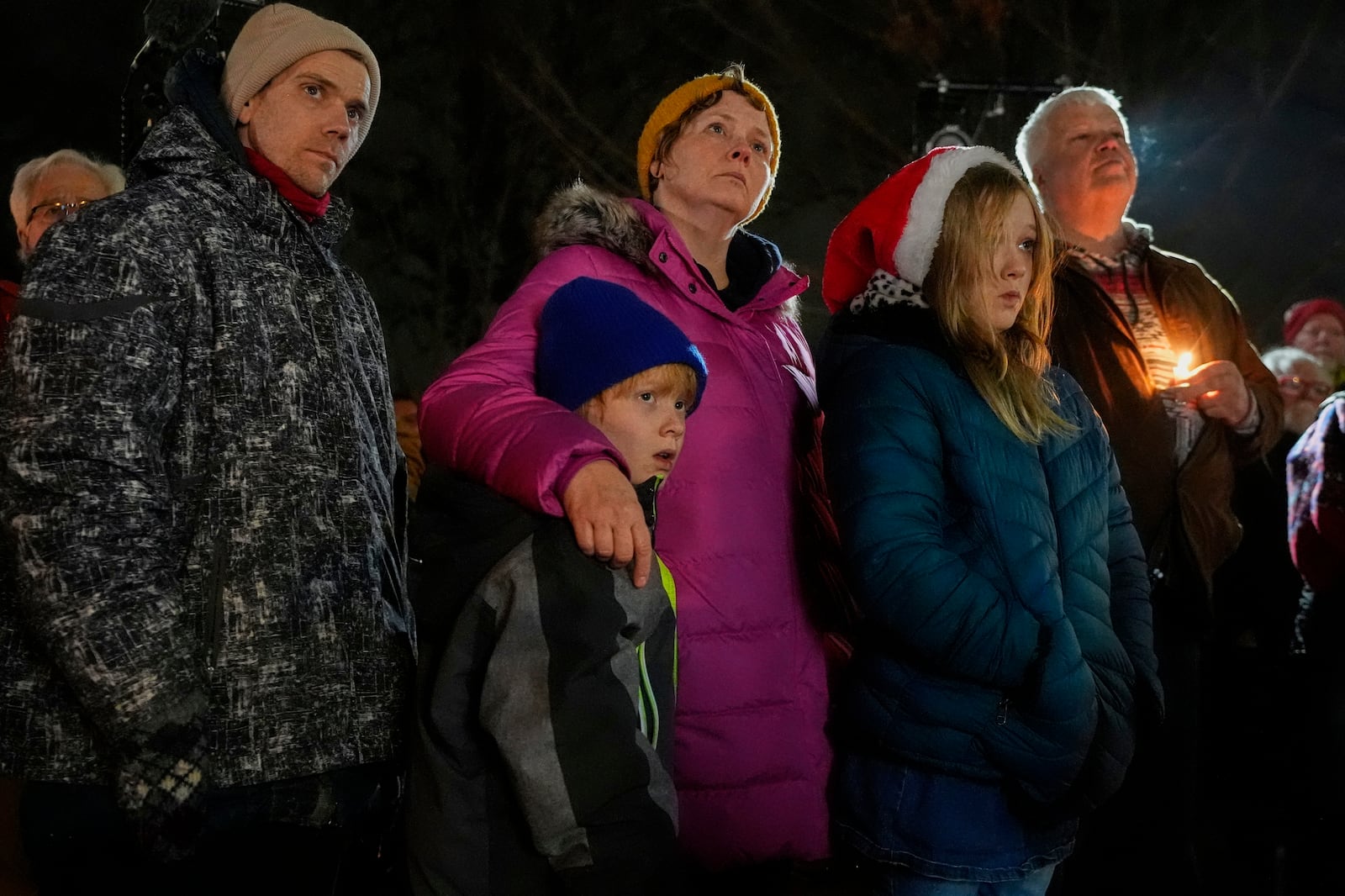 Supporters hold candles during a candlelight vigil Tuesday, Dec. 17, 2024, outside the Wisconsin Capitol in Madison, Wis., following a shooting at the Abundant Life Christian School on Monday, Dec. 16. (AP Photo/Morry Gash)