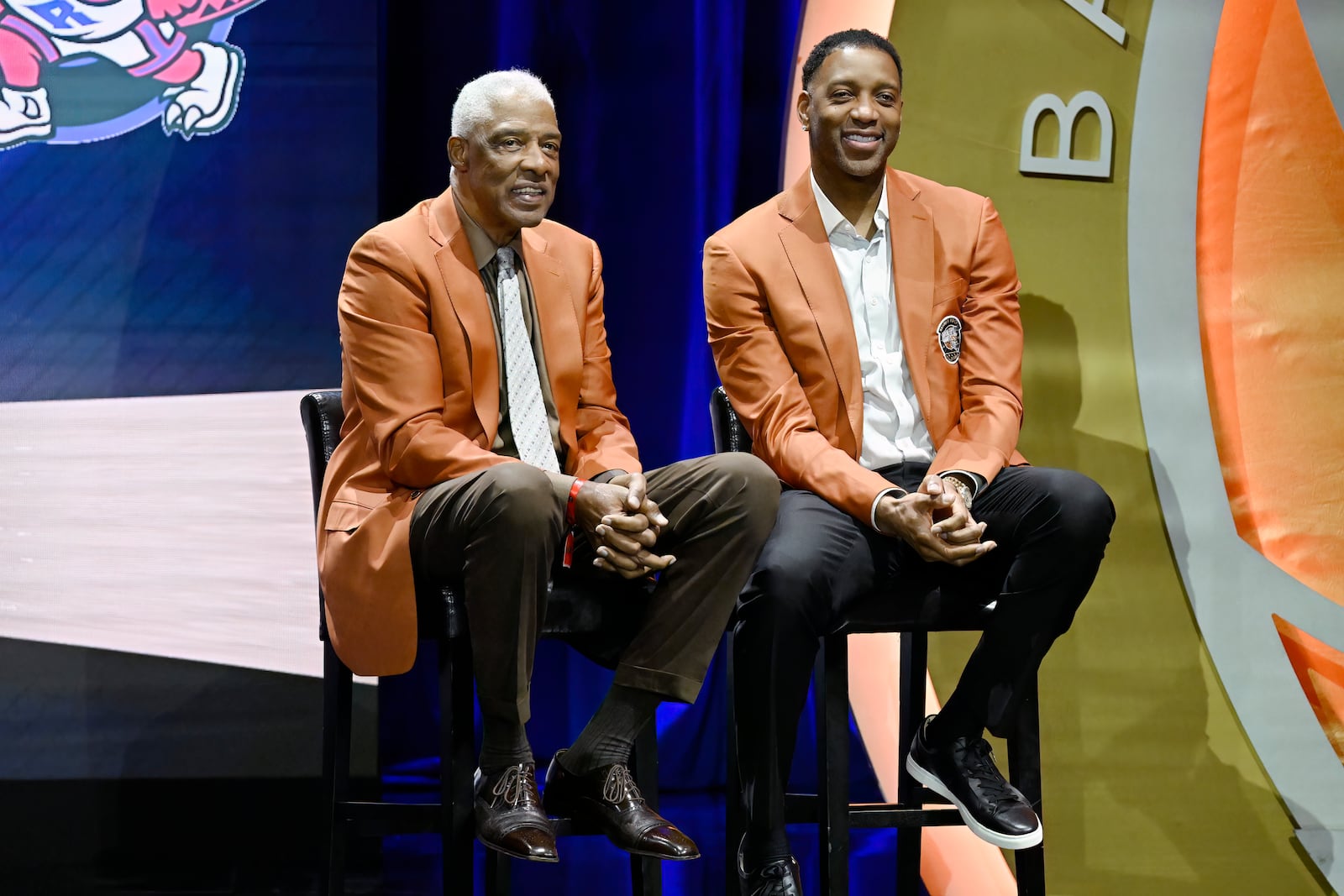 Julius Erving, left, and Tracy McGrady, right, listen to as Vince Carter is enshrined in the Basketball Hall of Fame, Sunday Oct. 13, 2024, in Springfield, Mass. (AP Photo/Jessica Hill)