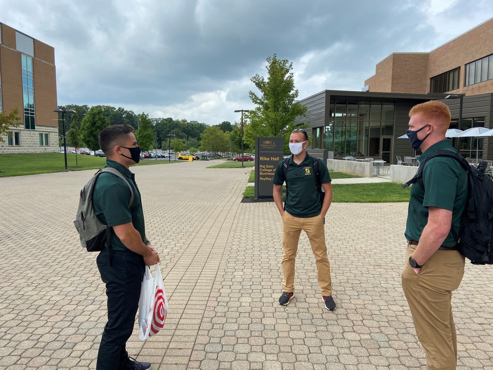 Wright State University students Caleb Matos, a junior in psychology; Philip Bertsch, a junior majoring in political science; and William Bayham, a mechanical engineering major have a conversation on campus Thursday afternoon. The friends, who are all ROTC cadets, said the university has done a great job of putting place safety measures to limit the spread of COVID-19/ Ismail Turay Jr.