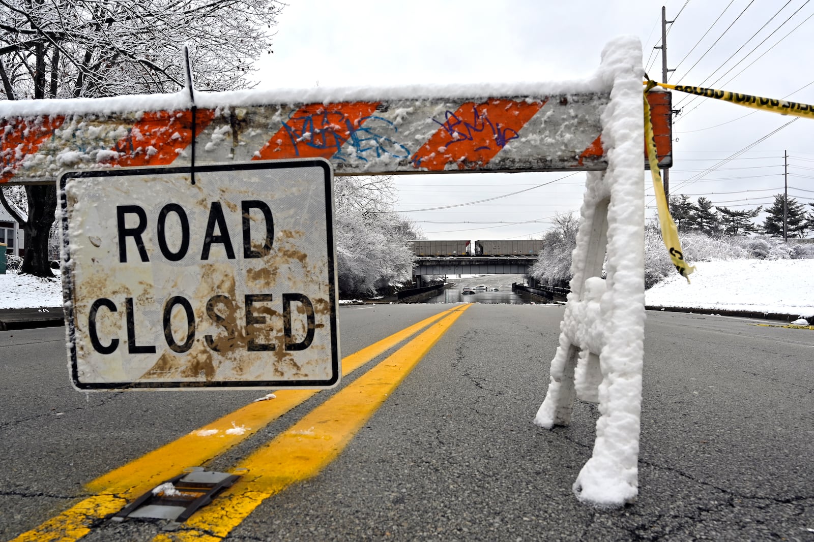 A road is closed due to flooding in Louisville, Ky., Sunday, Feb. 16, 2025. (AP Photo/Timothy D. Easley)