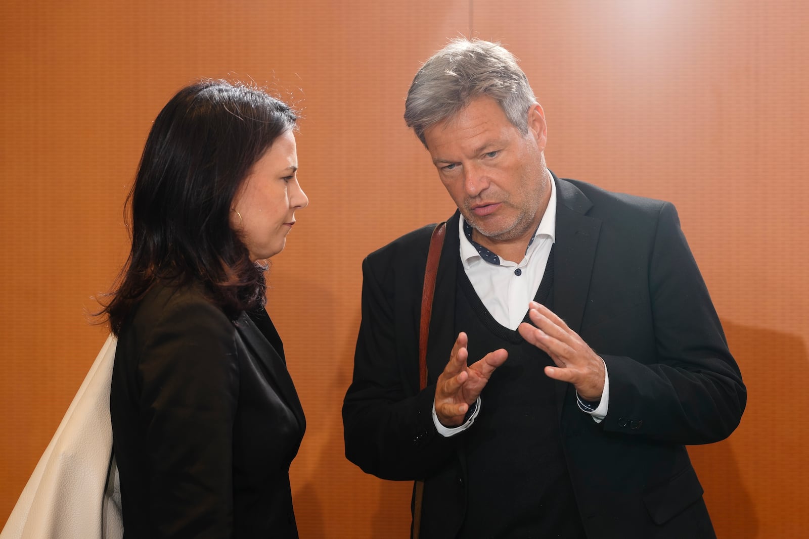 German Foreign Minister Annalena Baerbock, left, talks with Economy and Climate Minister Robert Habeck, right, as they arrive for the weekly cabinet meeting at the chancellery in Berlin, Germany, Wednesday, Nov. 6, 2024. (AP Photo/Markus Schreiber)