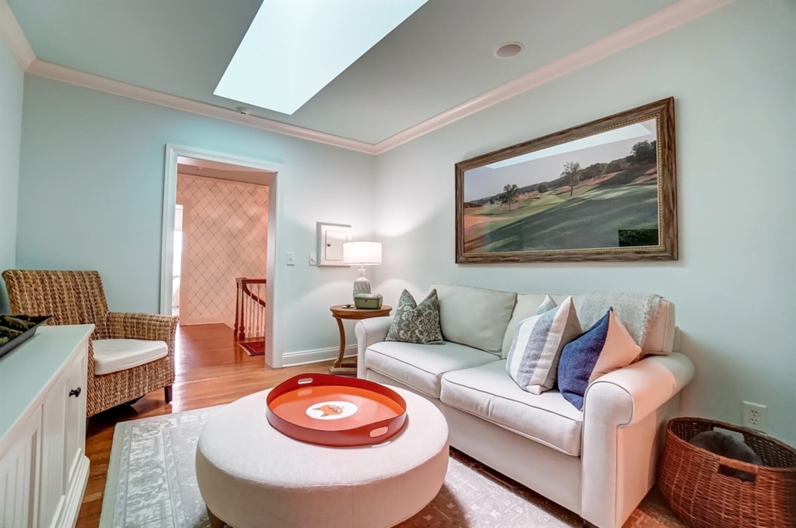 A sitting room has a skylight and is passage to the hidden primary suite retreat.