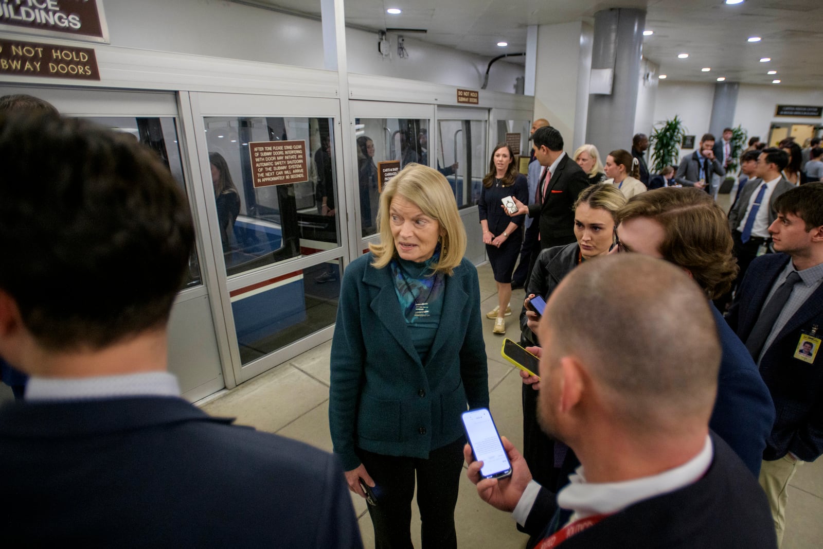 Sen. Lisa Murkowski, R-Alaska, talks with reporters as she makes her way through the Senate subway, Thursday, Jan. 23, 2025, in Washington. (AP Photo/Rod Lamkey, Jr.)