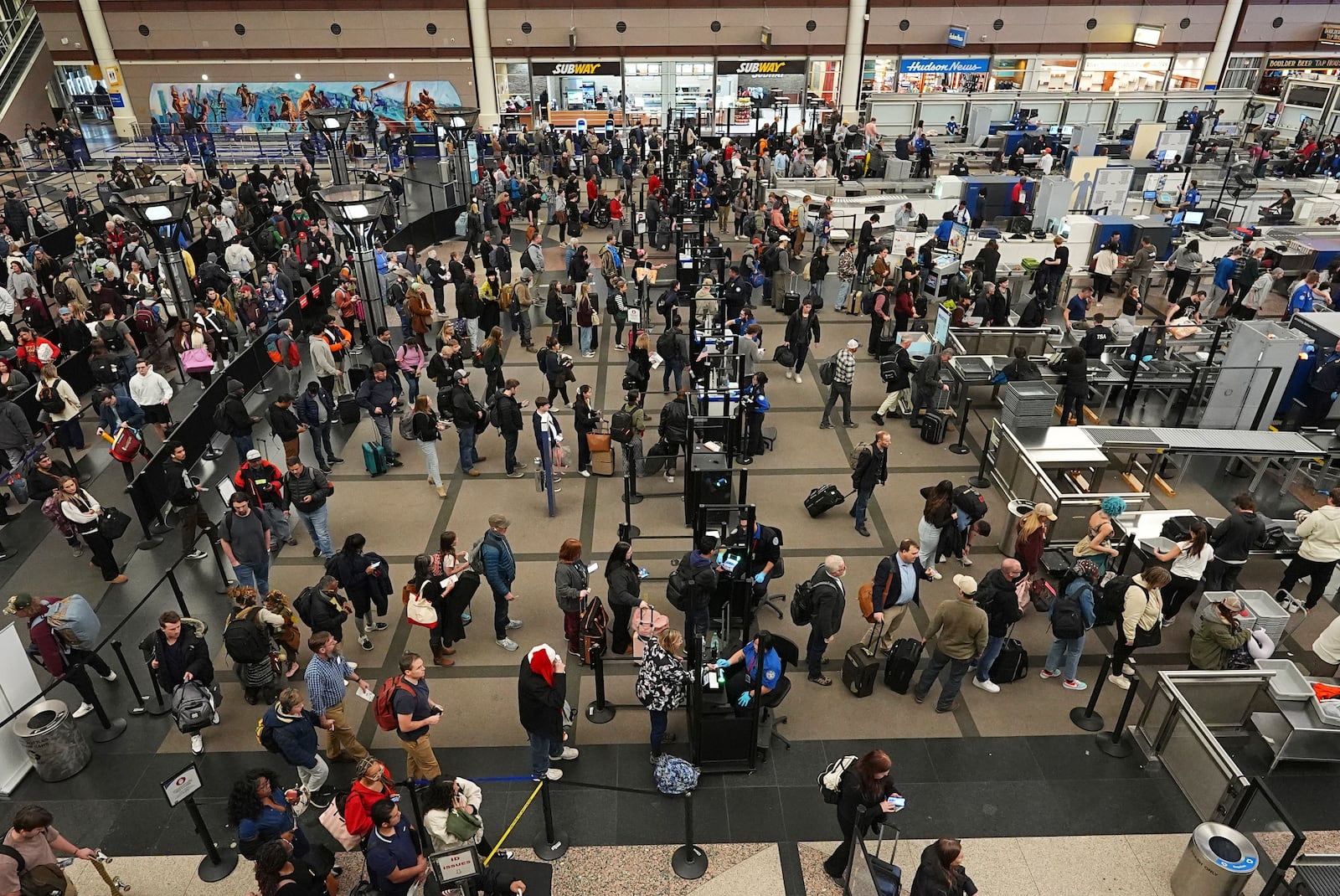 Travelers wade through the south security checkpoint in Denver International Airport Thursday, Dec. 19, 2024, in Denver. (AP Photo/David Zalubowski)