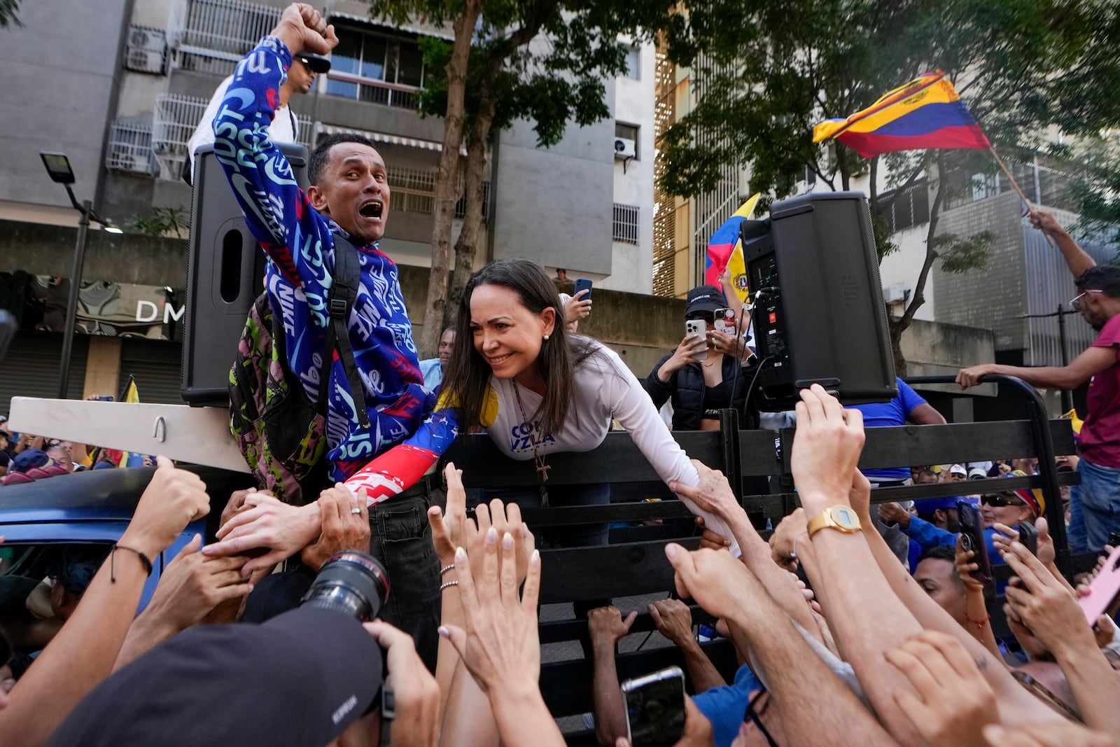 Opposition leader Maria Corina Machado greets supporters during a protest against Venezuelan President Nicolas Maduro the day before his inauguration for a third term in Caracas, Venezuela, Thursday, Jan. 9, 2025. (AP Photo/Matias Delacroix)