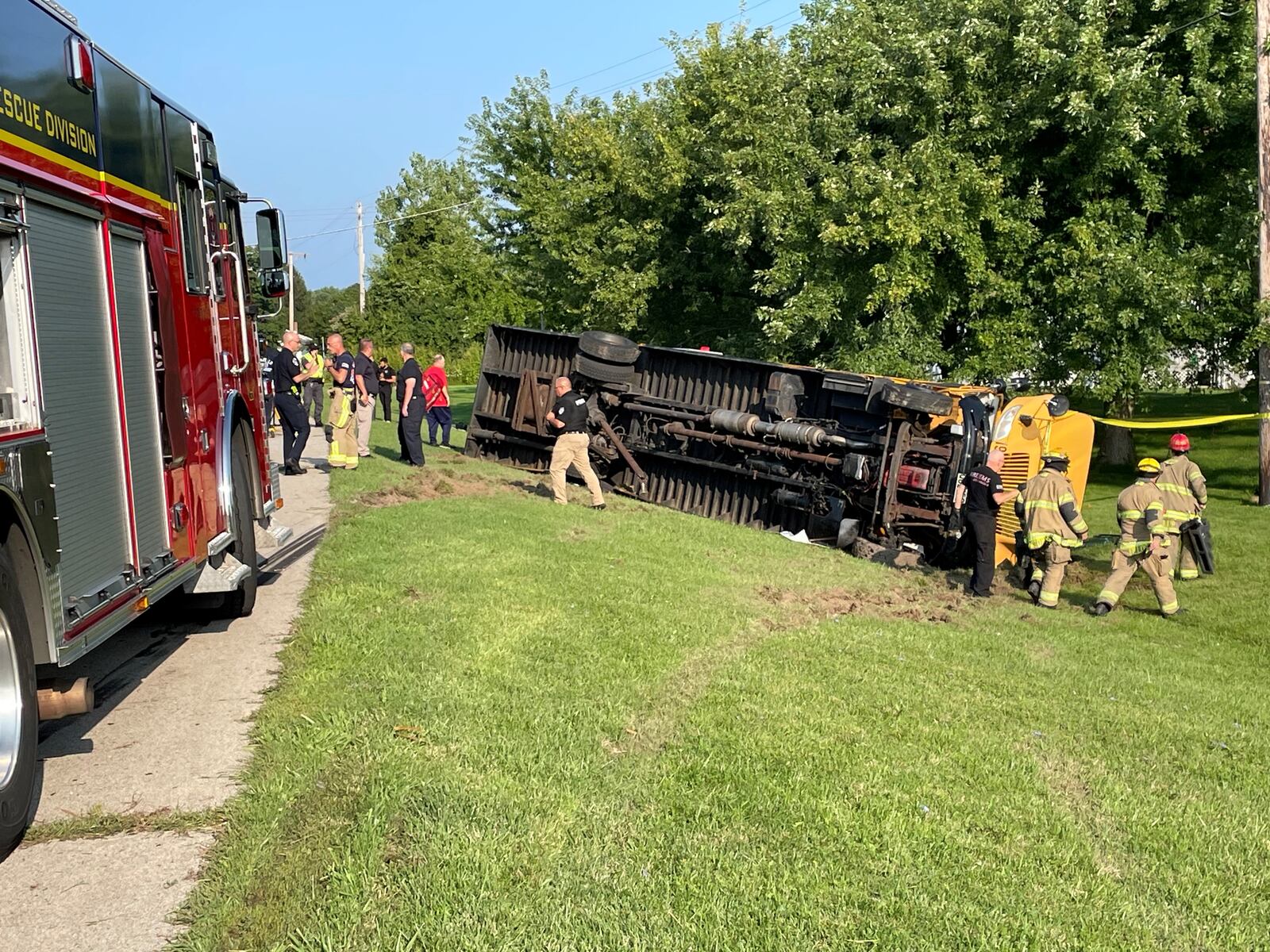 A Northwestern local schools bus with elementary schoolers inside flipped over in an accident involving another vehicle in the 4100 block of Troy Road (Ohio 41) at Lawrenceville near the German Twp. fire station on Tuesday, Aug. 22, 2023. BILL LACKEY/STAFF