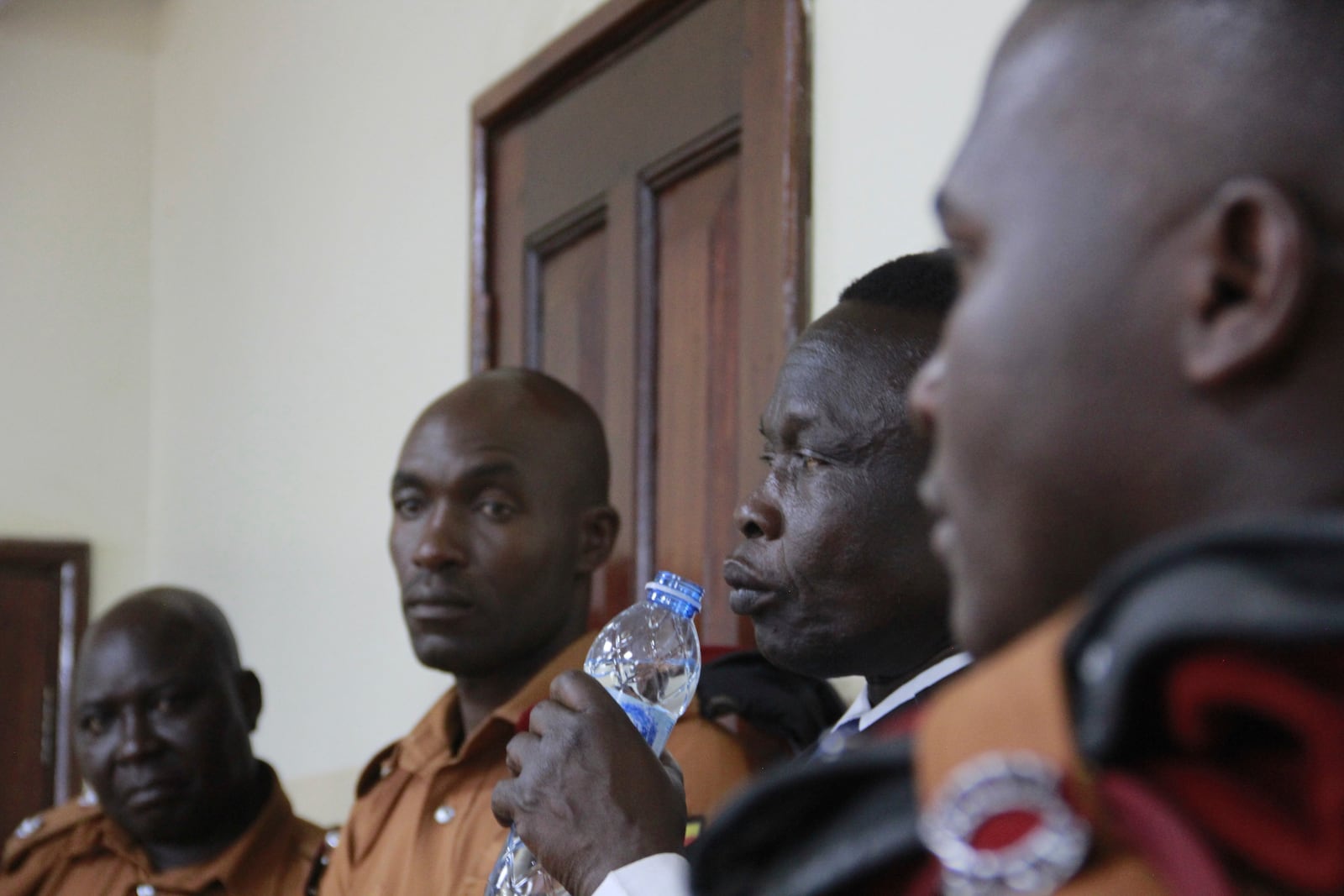 Former commander of the Lord's Resistance Army rebel Thomas Kwoyelo, drinks water as he listens to the court ruling in Gulu, Uganda Friday, Sept. 25, 2024. (AP Photo)