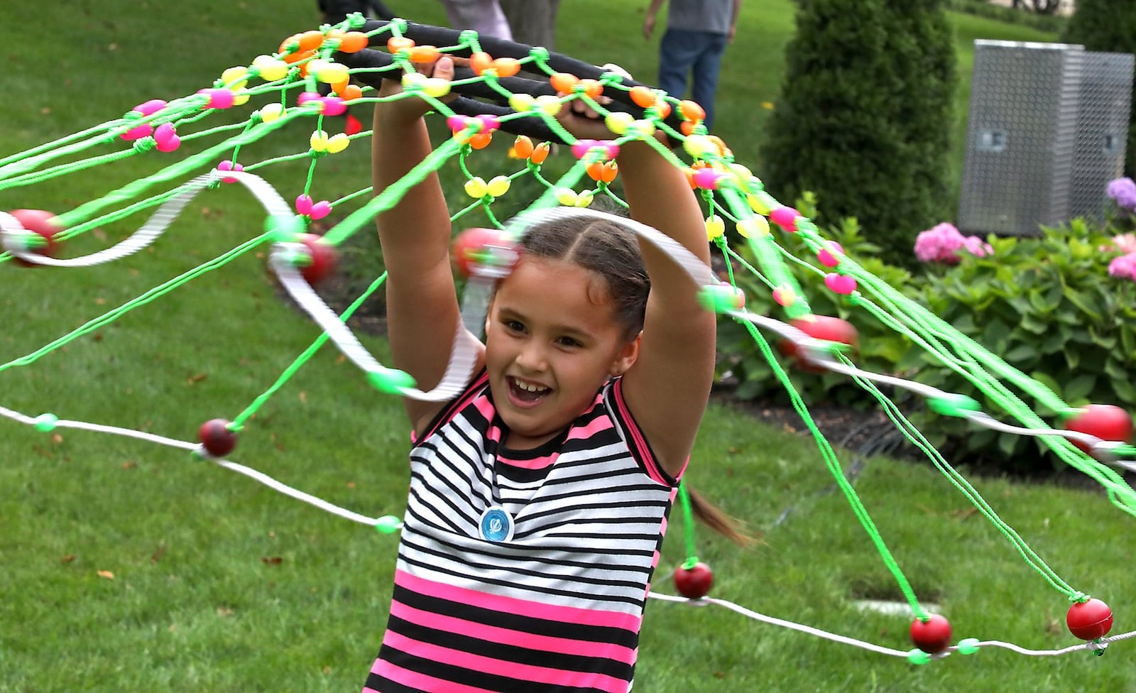 Sukhman Kaur spins a wheel with brightly colored beads on a string during last year’s CultureFest. BILL LACKEY/STAFF