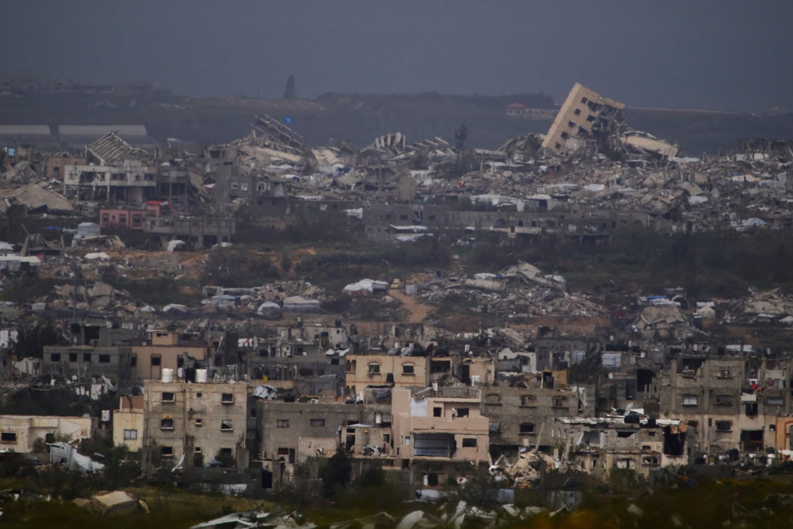 Buildings destroyed during the Israeli air and ground offensive in the Gaza Strip as seen from southern Israel, Thursday, March 20, 2025. (AP Photo/Leo Correa)