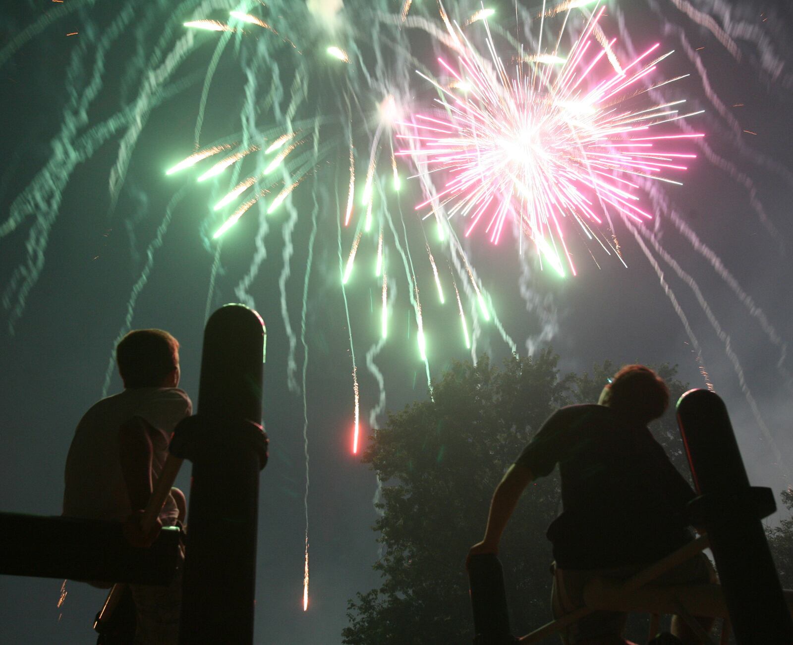 Kids watch from the playground as Rozzi's Famous Fireworks fill the sky at Harbin Park in Fairfield during the Red White and Kaboom celebration, Friday, July 3, 2009. GREG LYNCH/FILE