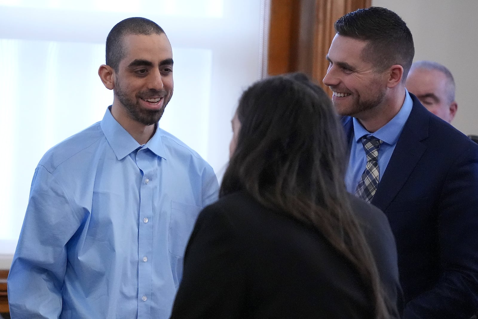 Hadi Matar, left, talks with his defense team before leaving the courtroom at the Chautauqua County courthouse after his second day of trial, Tuesday, Feb. 11, 2025, in Mayville, N.Y. Matar is charged with stabbing famed author Salman Rushdie. (AP Photo/Gene J. Puskar)