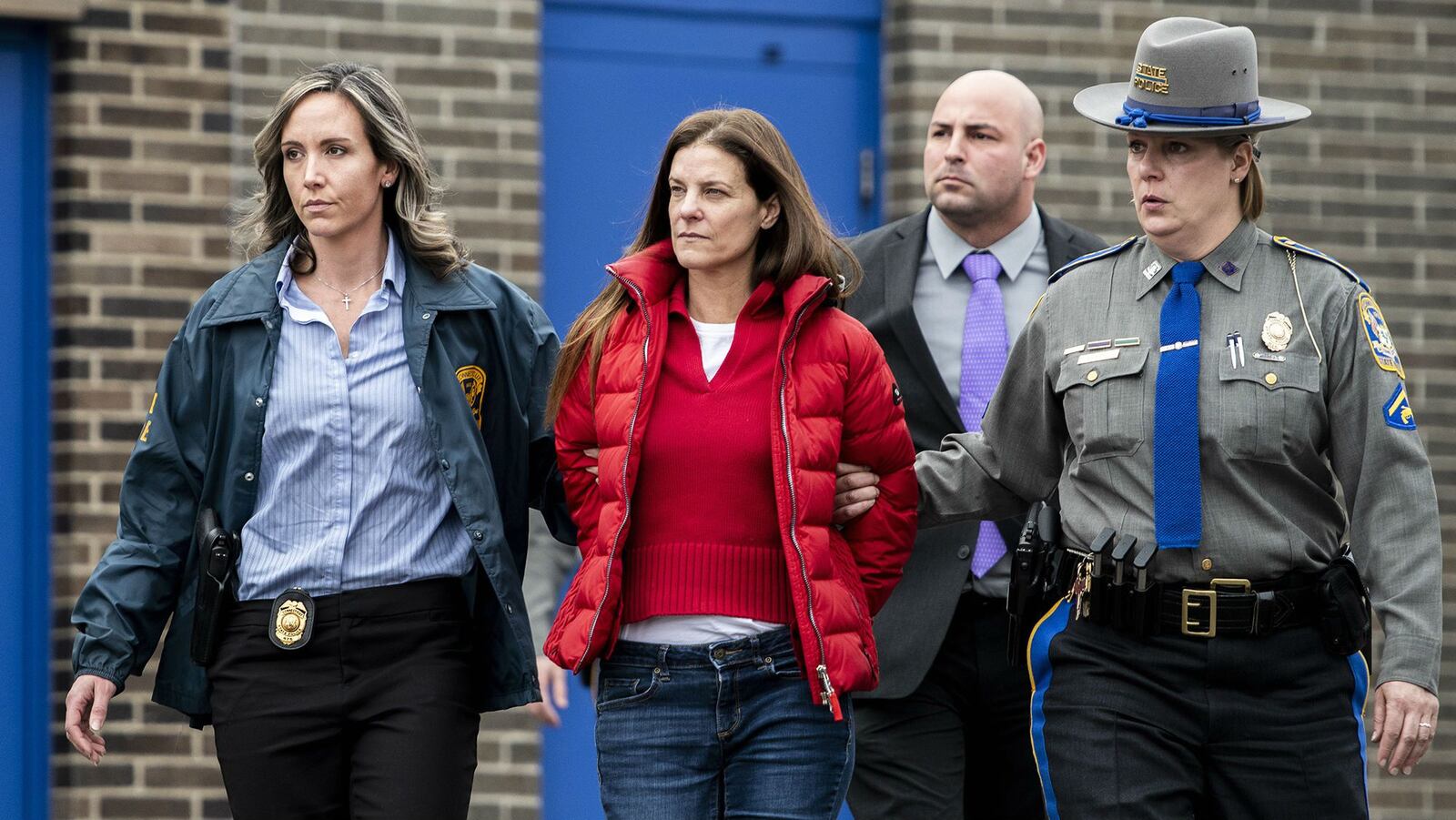 Michelle Troconis, pictured being escorted Tuesday, Jan. 7, 2020, from the Connecticut State Police barracks in Bridgeport, has been charged with conspiracy to commit murder in the presumed death of her boyfriend's estranged wife, Jennifer Dulos, 50, of New Canaan. Jennifer Dulos was last seen alive May 24, 2019, as she dropped the couple’s children off at school. Her body has not been found. (Kassi Jackson/Hartford Courant/Tribune News Service via Getty Images)