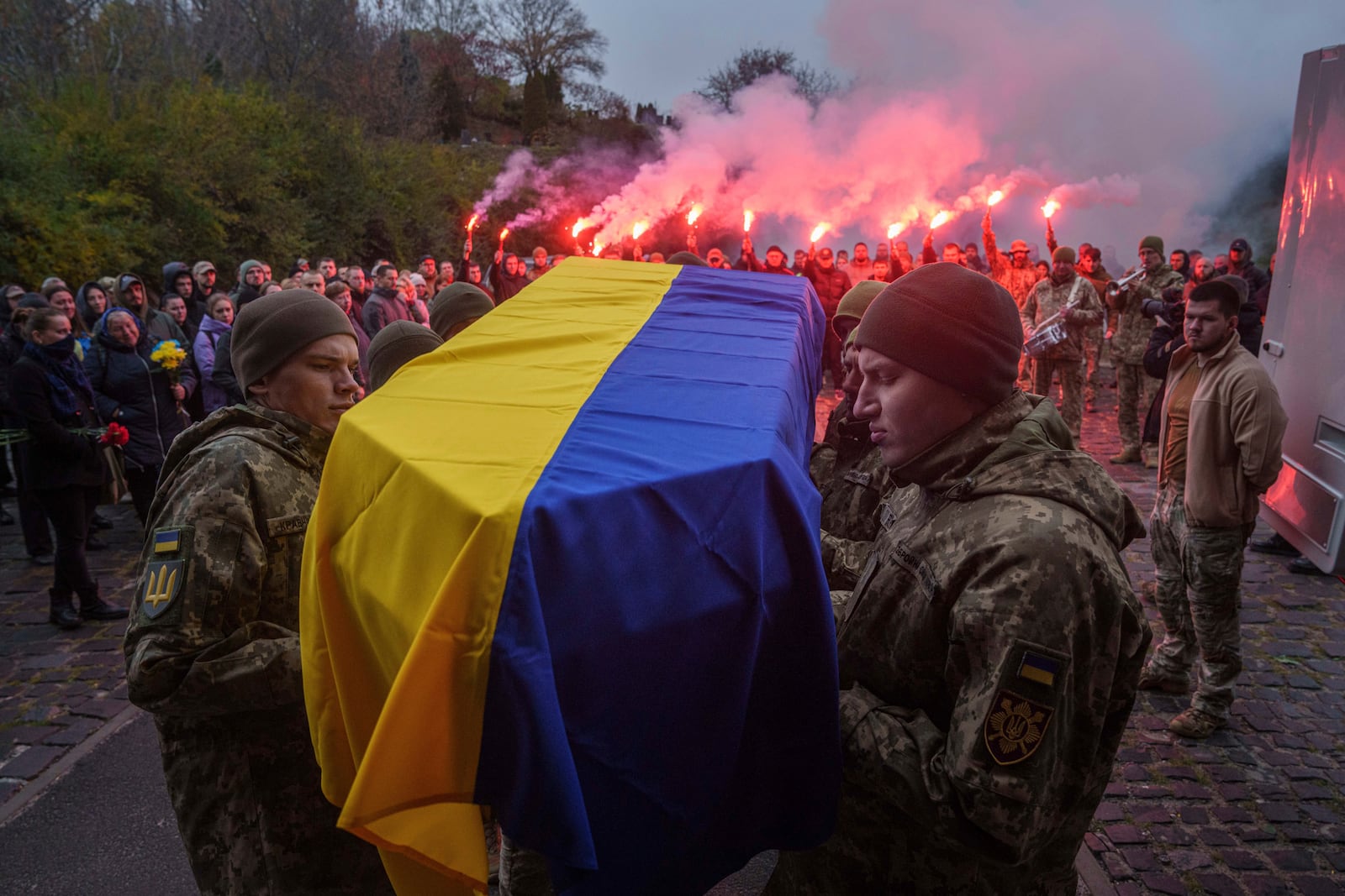 Honour Guard carry a coffin of fallen Ukrainian serviceman of 3rd assault brigade Danylo Liashkevych, known as "Berserk", who was killed together with his girlfriend Valentyna Nagorna, known as "Valkiria", during the funeral ceremony at a crematorium in Kyiv, Ukraine, Friday Nov. 8, 2024. (AP Photo/Evgeniy Maloletka)