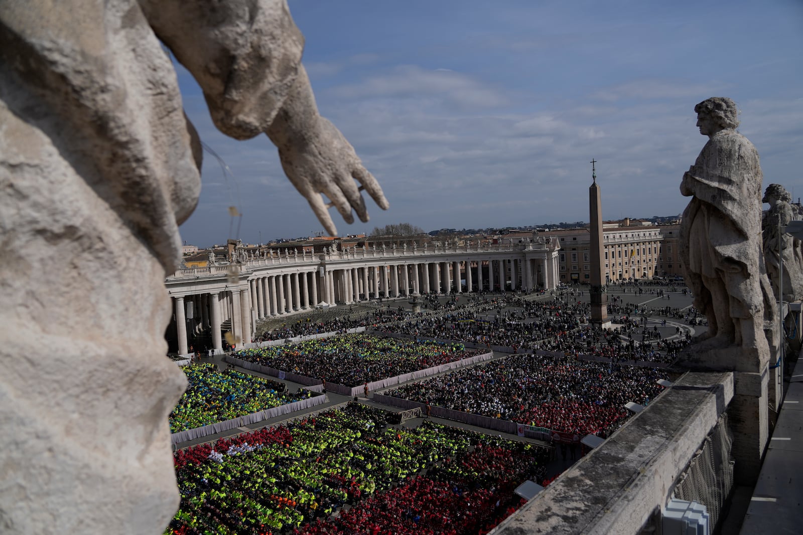 Members of different organizations of volunteers follow Cardinal Michael Czerny, delegate of Pope Francis who is being treated for pneumonia at Rome's Agostino Gemelli Polyclinic, celebrating a mass for the world of volunteers in St. Peter's Square at The Vatican, Sunday, March 9, 2025. (AP Photo/Gregorio Borgia)