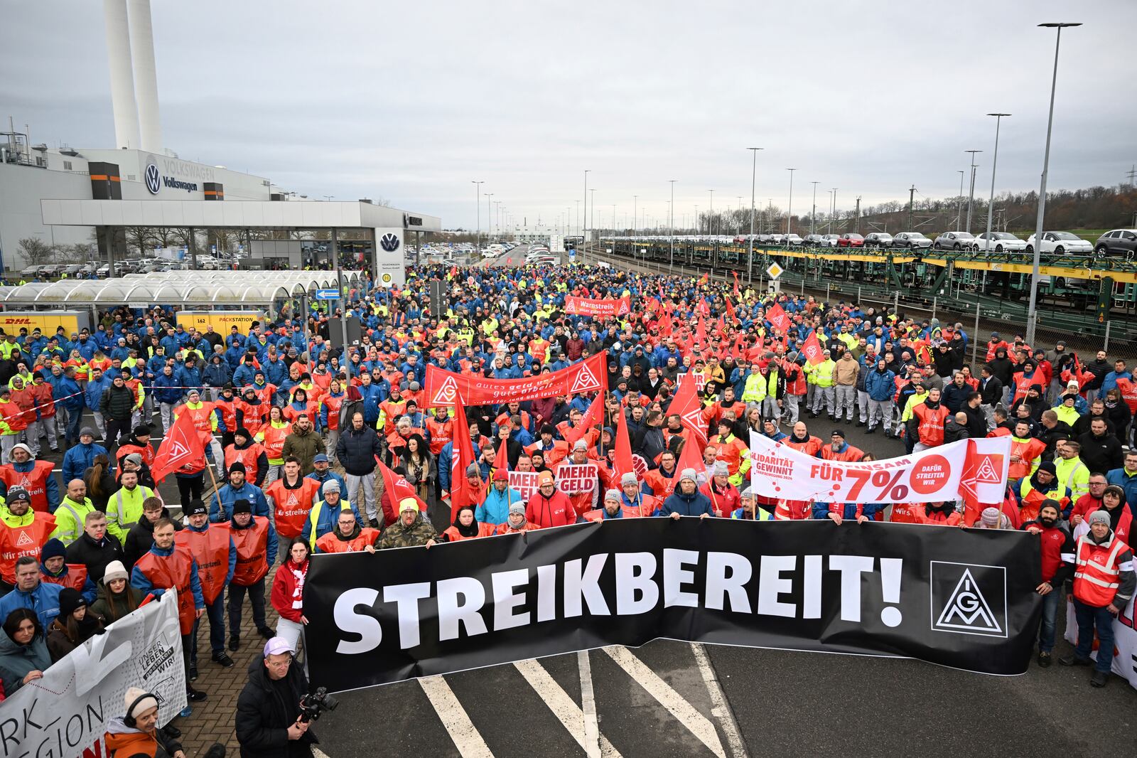 Volkswagen workers march holding a sign with writing reading in German "Ready to Strike!" on the first day of a nationwide warning Volkswagen workers' strike, in Zwickau, Germany, Monday, Dec. 2, 2024. (Hendrik Schmidt/dpa via AP)