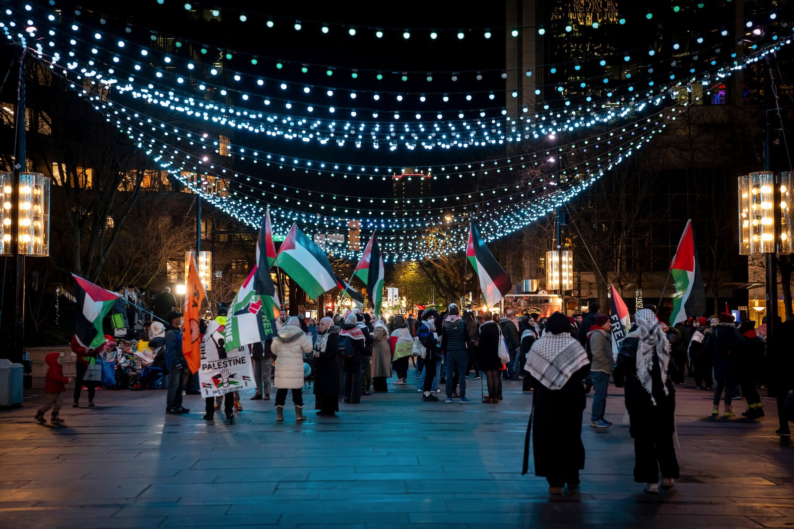 People gather to celebrate the Gaza ceasefire and hostage deal reached between Israel and Hamas in Vancouver, British Columbia, Wednesday, Jan. 15, 2025. (Ethan Cairns/The Canadian Press via AP)