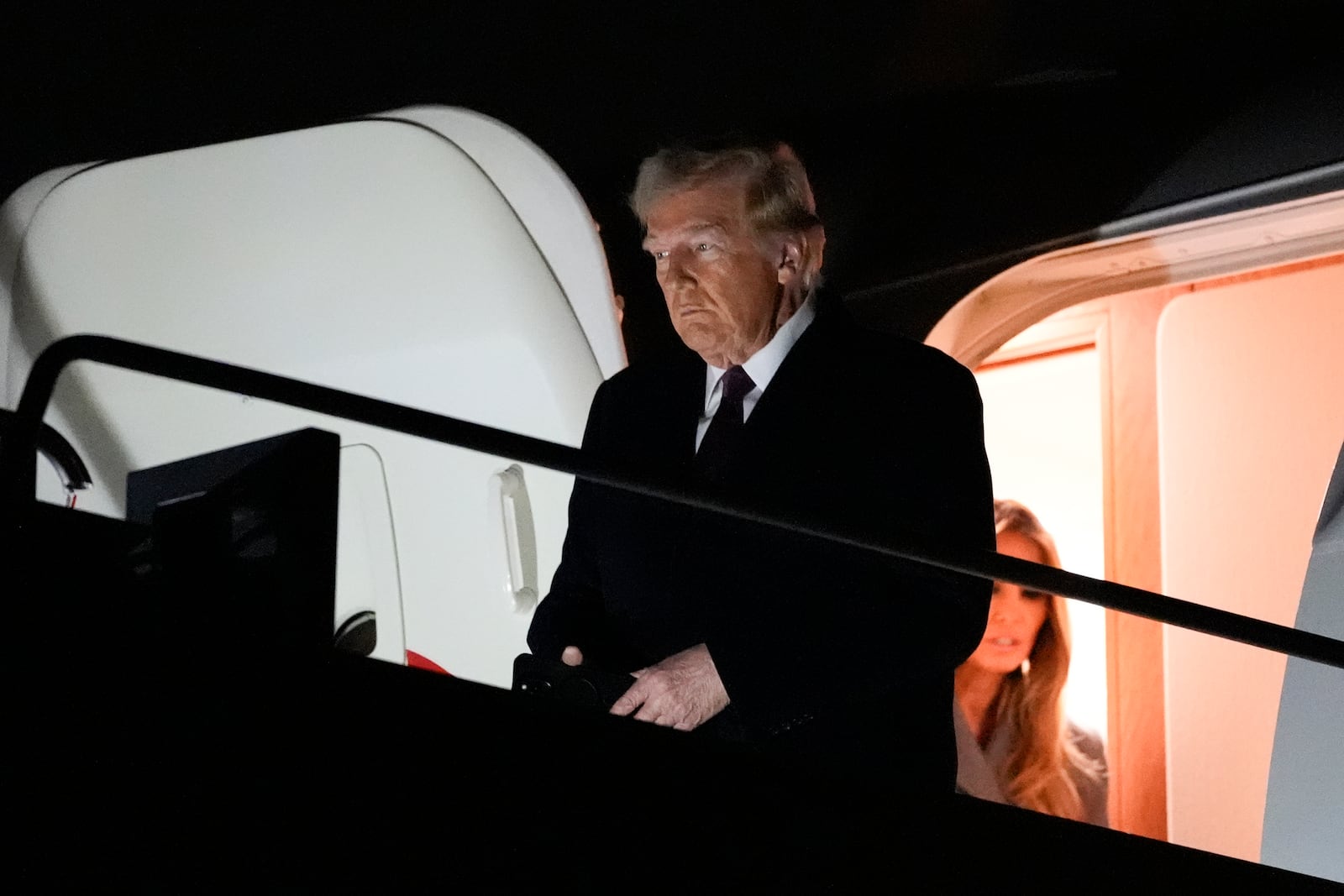 President-elect Donald Trump and Melania Trump, walk off an Air Force Special Mission airplane as they arrives at Dulles International Airport, Saturday, Jan. 18, 2025, in Dulles, Va. (AP Photo/Alex Brandon)