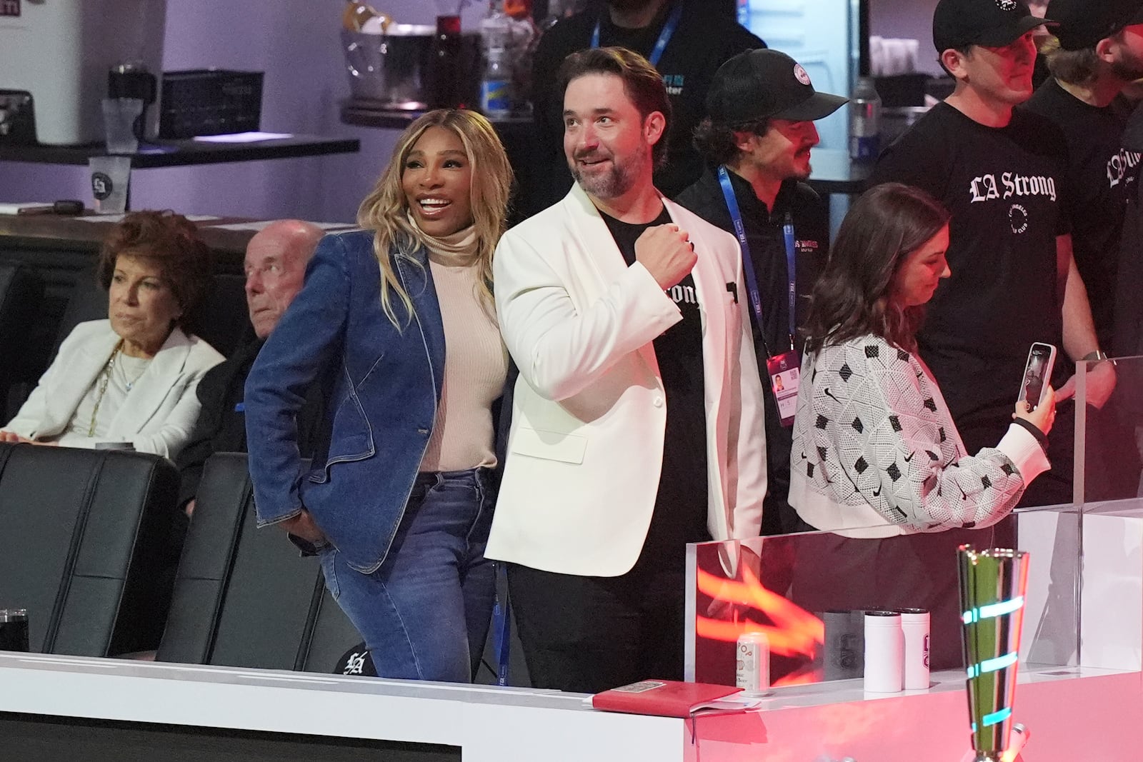 Serena Williams and her husband Alexis Ohanian stand during player introductions before a match between Los Angeles Golf Club and Jupiter Links Golf Club, Tuesday, Jan. 14, 2025, in Palm Beach Gardens, Fla. (AP Photo/Marta Lavandier)