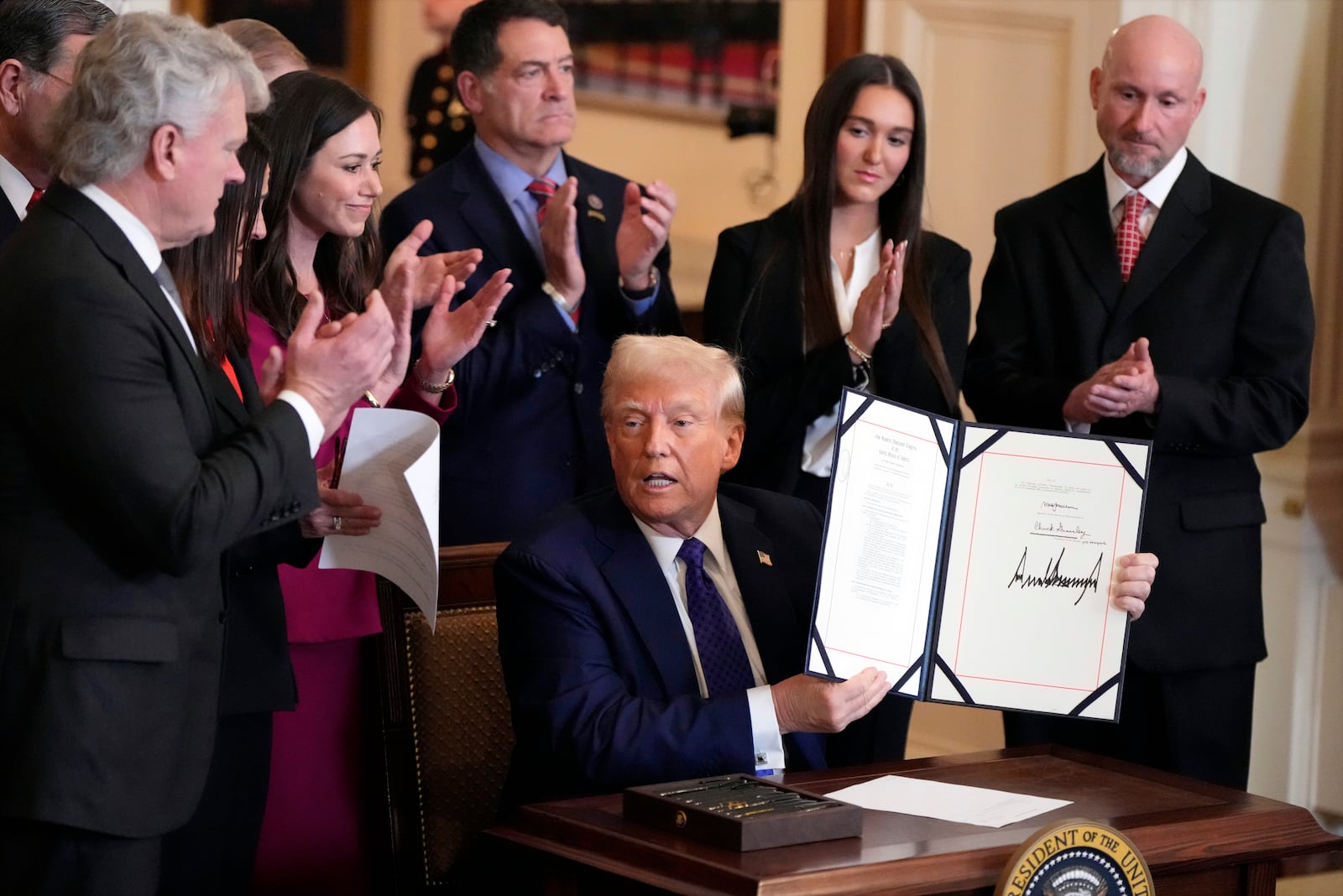 President Donald Trump signs the Laken Riley Act during an event in the East Room of the White House, Wednesday, Jan. 29, 2025, in Washington. (AP Photo/Alex Brandon)