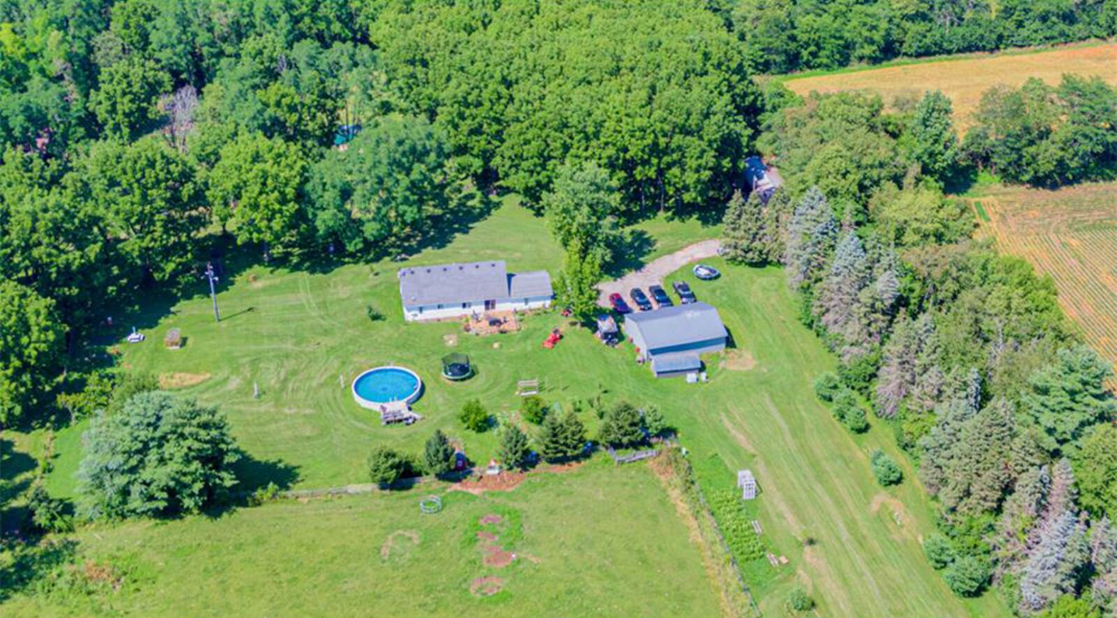 The 17.5-acre property includes two pole barns and three sheds, a chicken coup and greenhouse as well as an above-ground pool with deck.