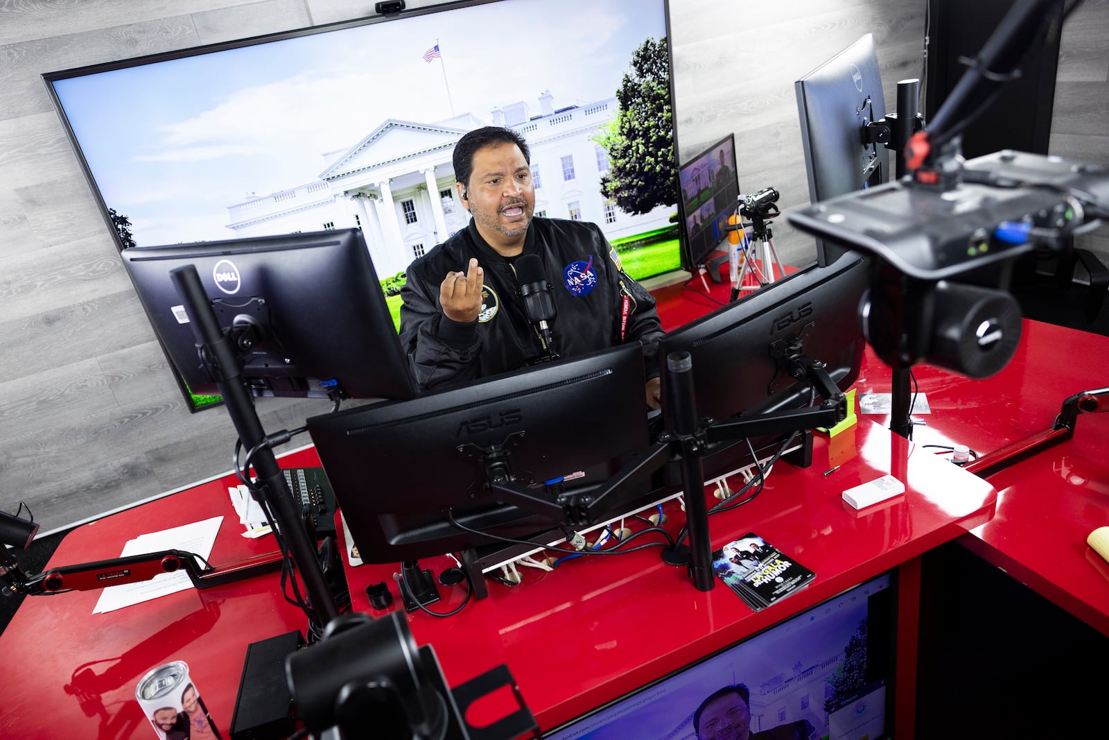 Radio host and owner of radio station La Mega 101.7 FM Victor Martinez on the air in Allentown, Pa., Tuesday, Oct. 15, 2024. (AP Photo/Ryan Collerd)