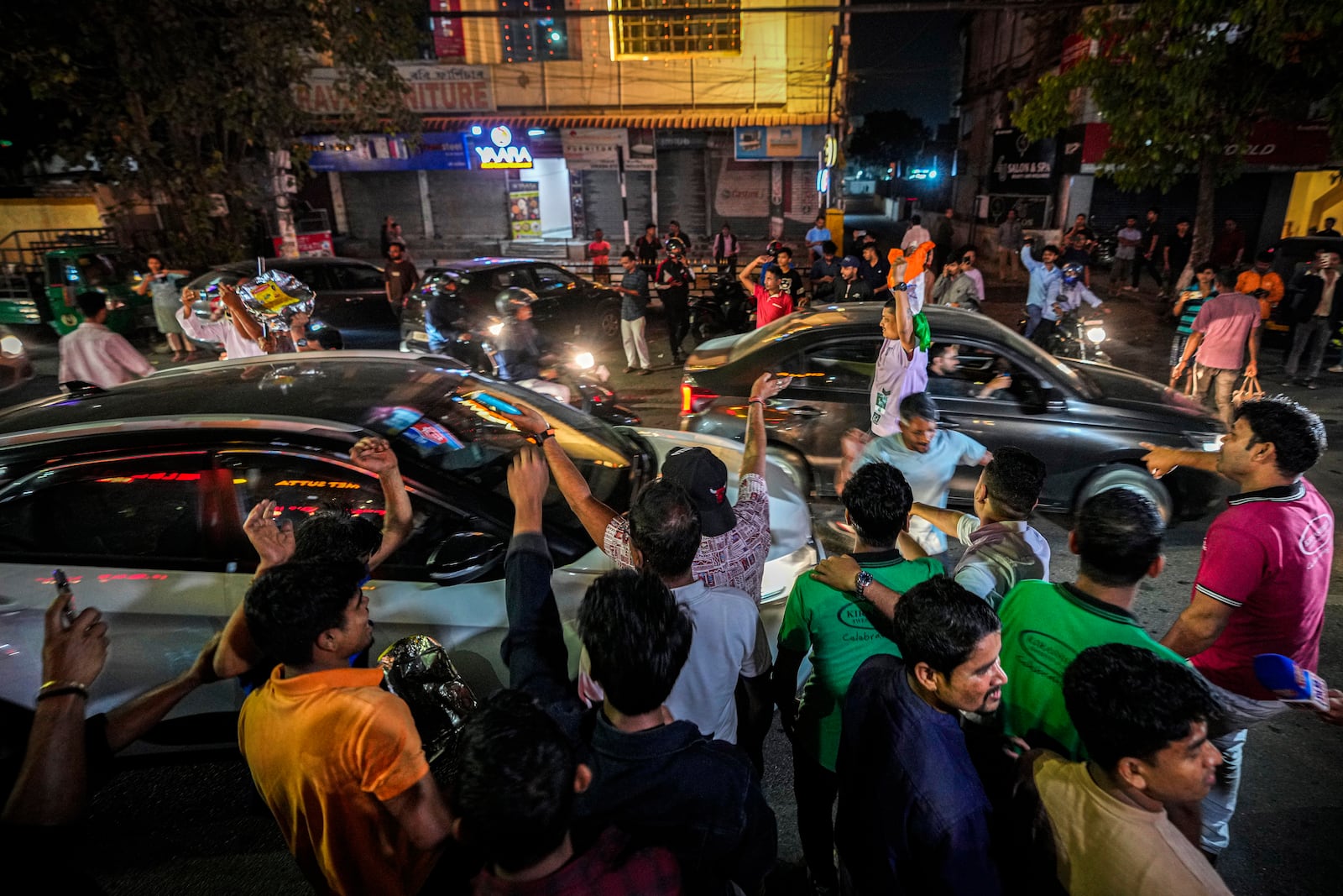 Cricket fans celebrate on a road after India wins the ICC Champions Trophy cricket final match between India and New Zealand in Dubai, in Guwahati, India, Sunday, March 9, 2025. (AP Photo/Anupam Nath)