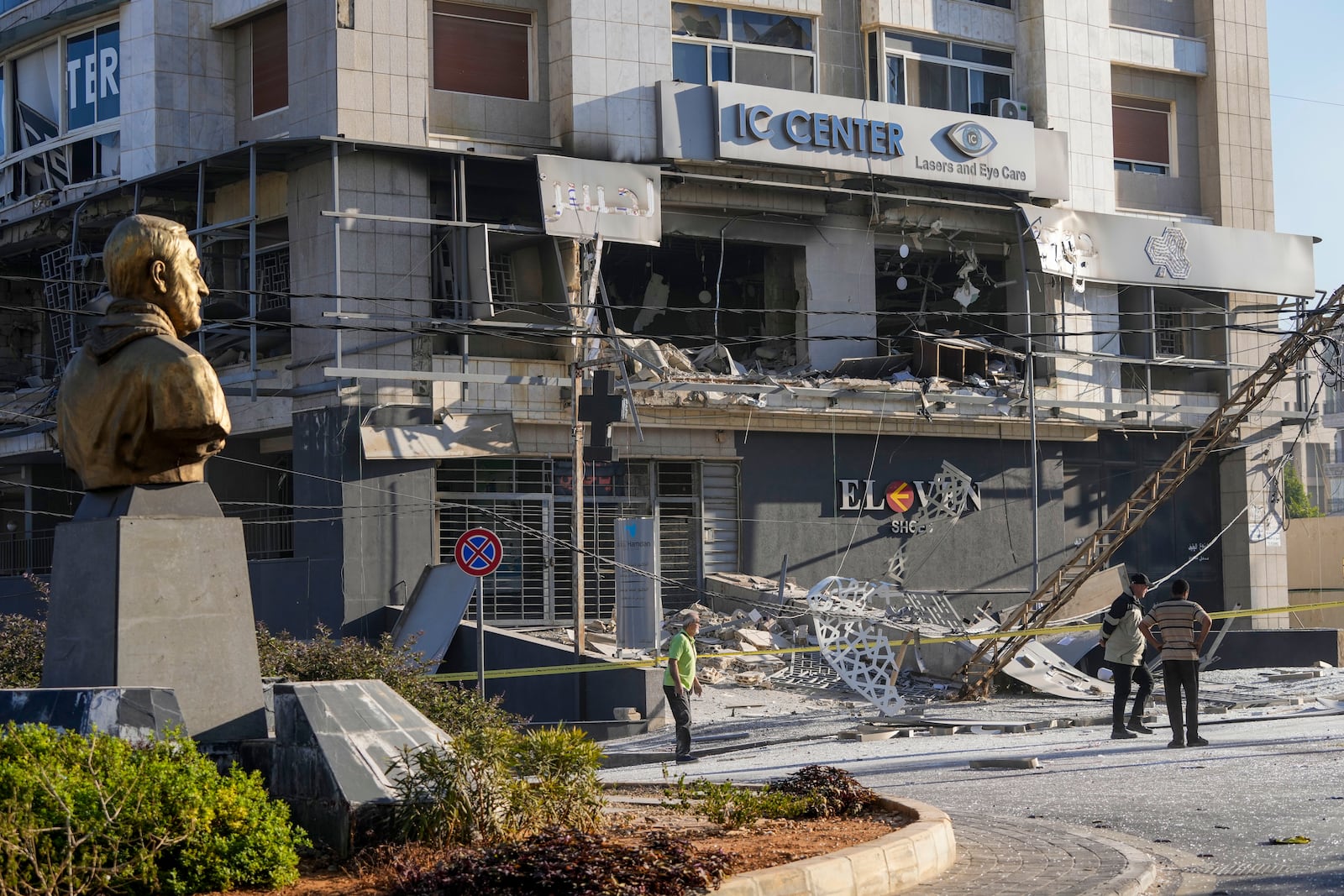 A bust of late Iranian General Qassem Soleimani, stands in front of a destroyed branch of the Hezbollah-run Qard al-Hassan at the site of an Israeli airstrike in Dahiyeh, Beirut, Lebanon, Monday, Oct. 21, 2024. (AP Photo/Hassan Ammar)