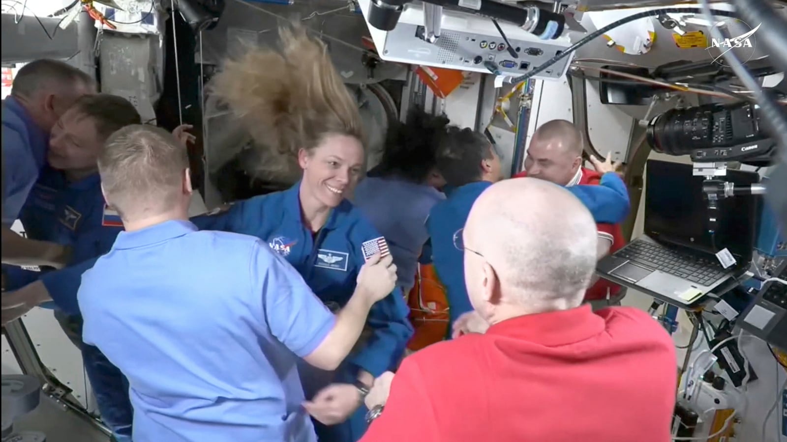 This image made from video by NASA shows astronauts, including Nichole Ayers, center left, greeting each other after a SpaceX capsule docked with the International Space Station, Sunday, March 16, 2025. (NASA via AP)