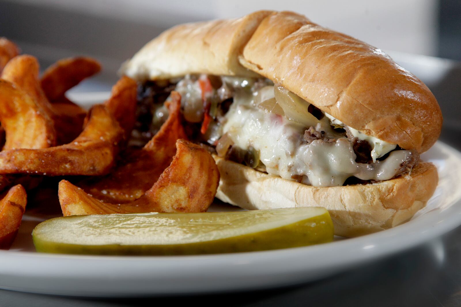 The Cheesesteak Hoagie at 416 Diner in Dayton's Oregon District, is made with grilled ribeye, onions, red and green peppers, diced mushrooms and provolone cheese seasoned with house made herbed mayo. LISA POWELL / STAFF