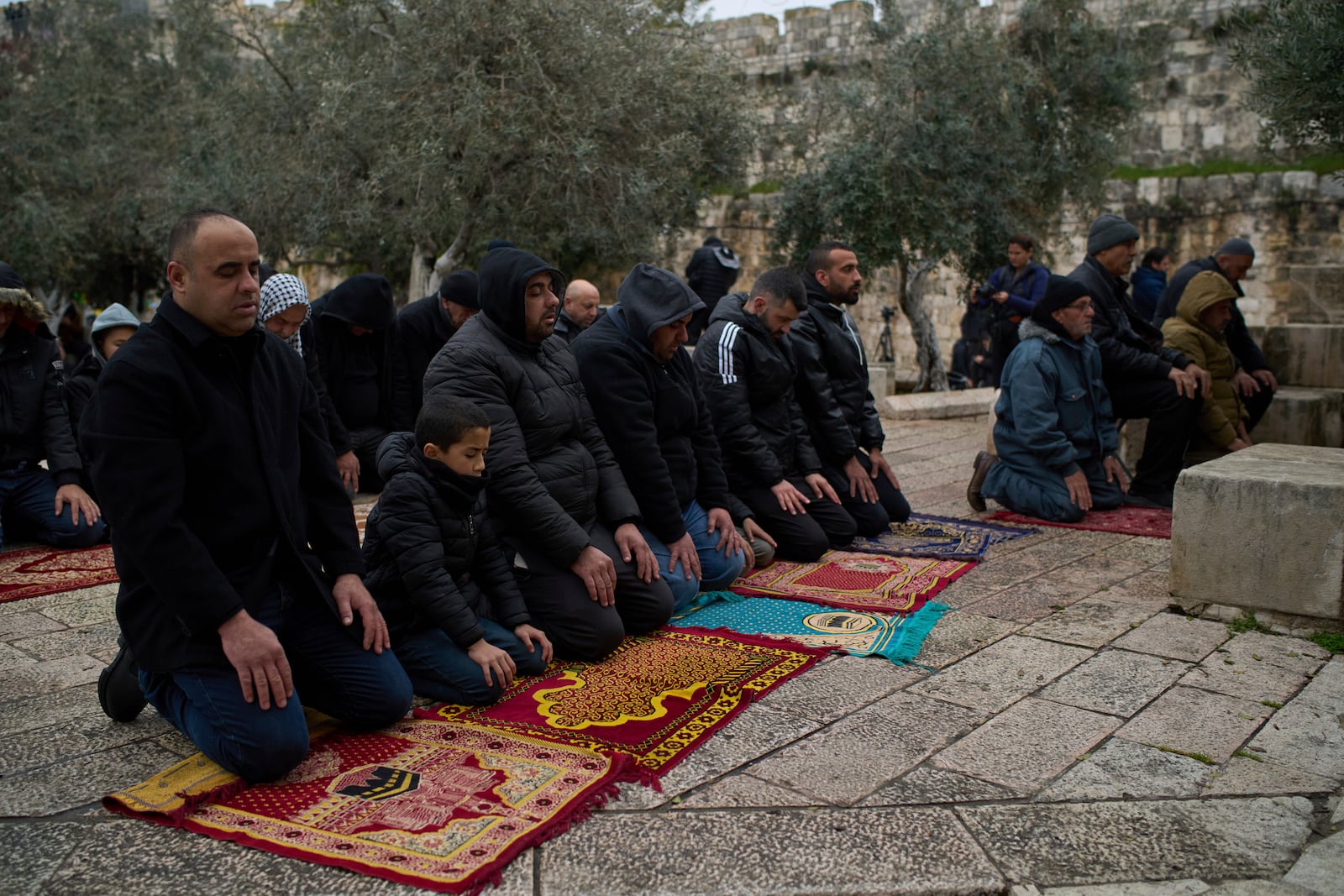 Muslims pray outside of the Al-Aqsa Mosque compound for the third Friday prayers of the holy month of Ramadan in the Old City of Jerusalem, Friday, March 7, 2025. (AP Photo/Leo Correa)