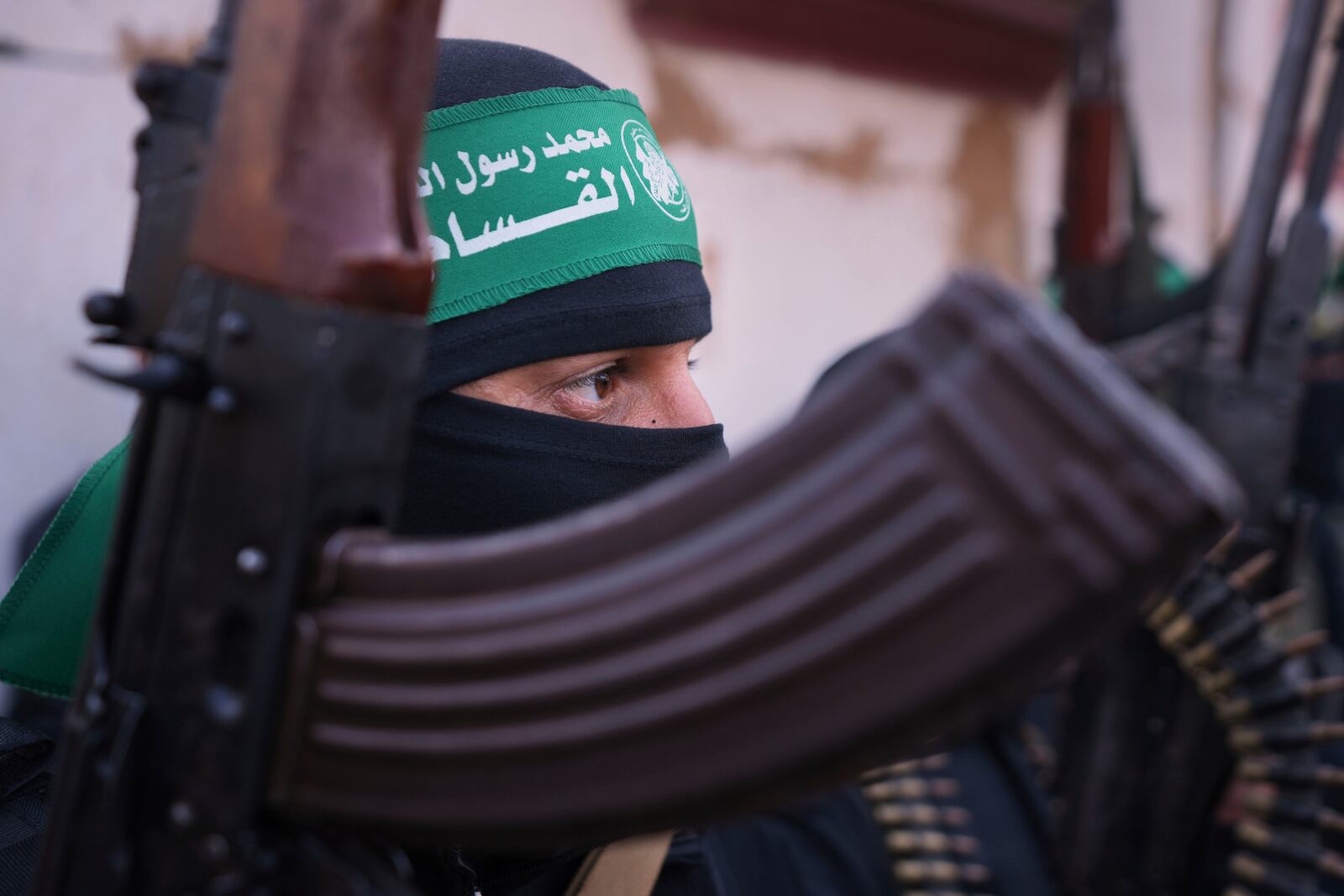 FILE - A member of the Islamic Jihad group holds his weapon as Israeli hostages are escorted to be handed over to the Red Cross in Khan Younis, southern Gaza Strip, Thursday Jan. 30, 2025. (AP Photo/Abdel Kareem Hana, File)