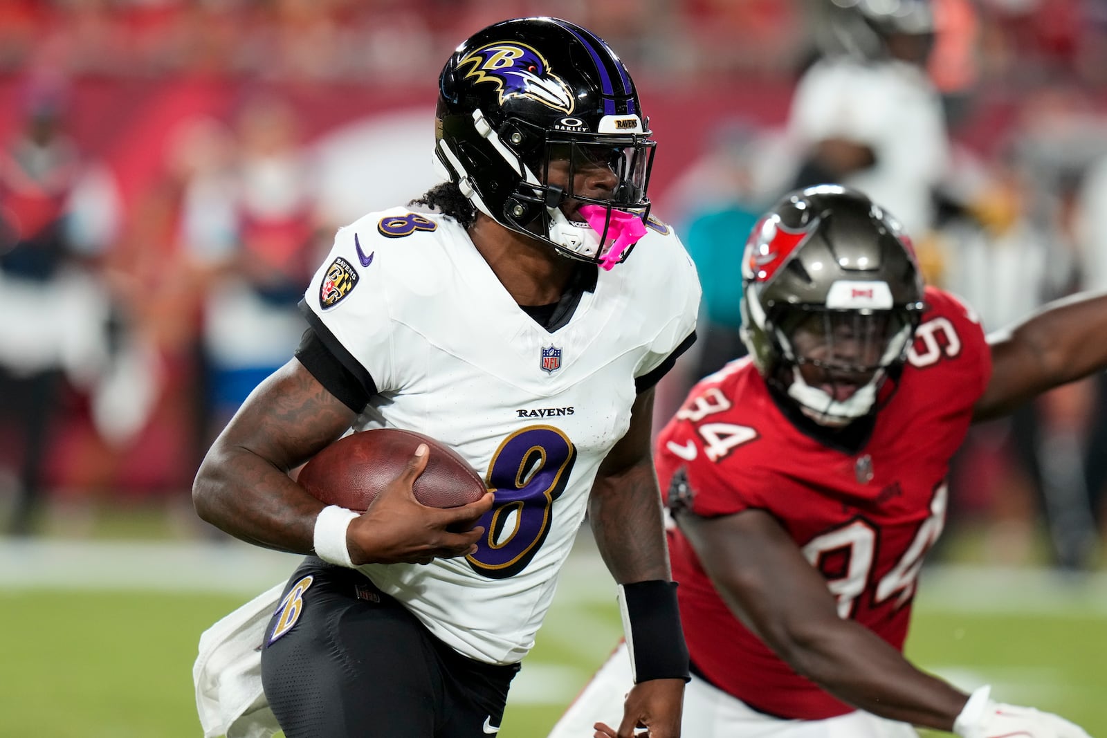 Baltimore Ravens quarterback Lamar Jackson (8) runs past Tampa Bay Buccaneers cornerback Bryce Hall (34) during the first half of an NFL football game, Monday, Oct. 21, 2024, in Tampa, Fla. (AP Photo/Chris O'Meara)