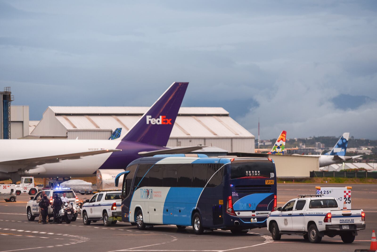 A bus carrying migrants from Central Asia and India, deported from the United States, arrives at the Juan Santamaría International Airport in San Jose, Costa Rica, Thursday, Feb. 20, 2025. (AP Photo/Jose Diaz)