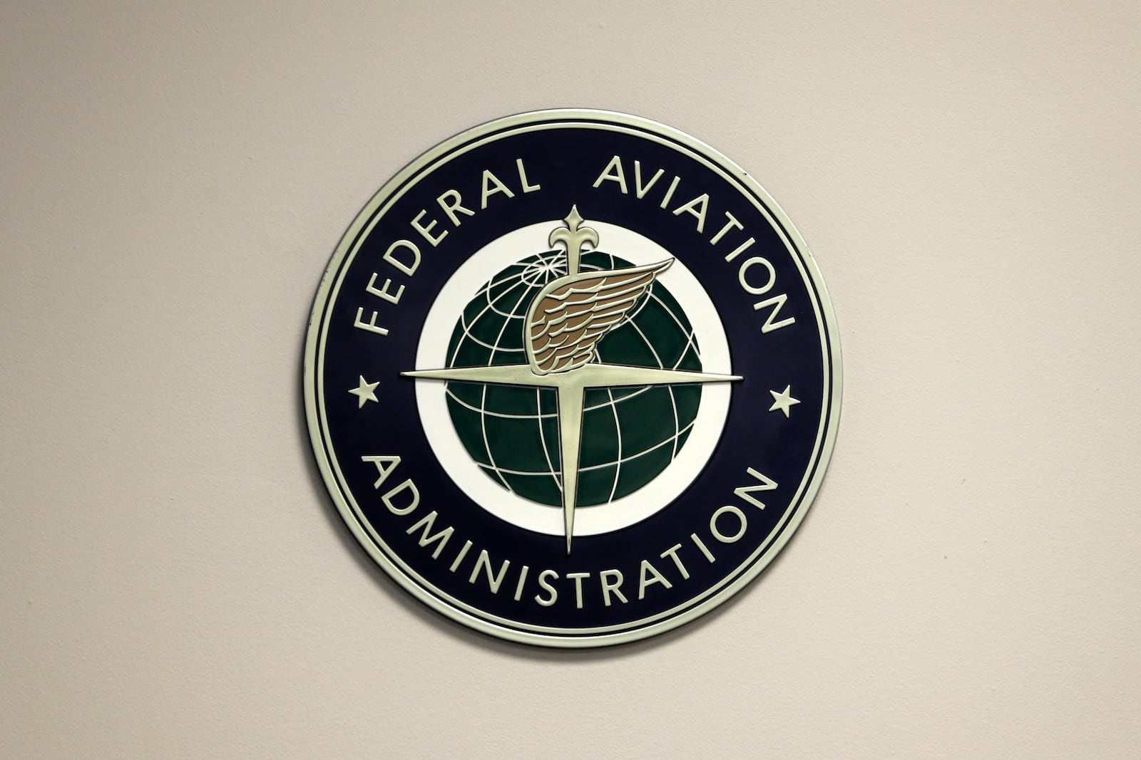 FILE - A Federal Aviation Administration sign hangs in the tower at John F. Kennedy International Airport in New York, March 16, 2017. (AP Photo/Seth Wenig, File)