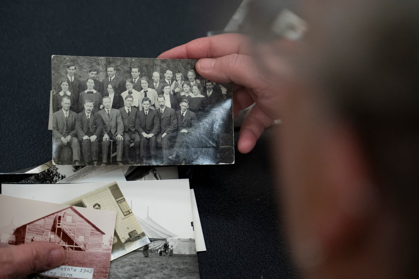 Pam Walton holds a photograph of “Two by Twos” ministers, also referred to as “workers,” at a library Monday, Dec. 9, 2004, in Wailea, Hawaii. Walton uses historic photos and other records to track the movements of spiritual leaders facing allegations of child sexual abuse within the sect. (AP Photo/Mengshin Lin)