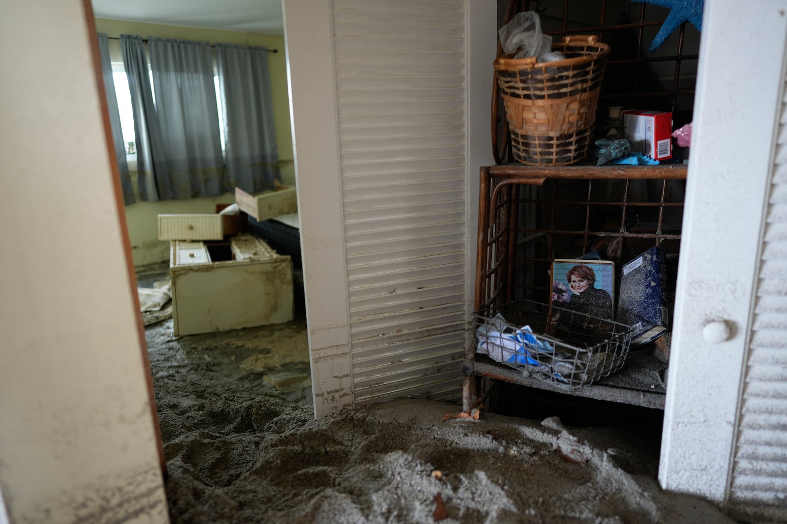 Several feet of sand fills a condo following the passage of Hurricane Milton at YCA Vacation Rental in Venice, Fla., Friday, Oct. 11, 2024. (AP Photo/Rebecca Blackwell)