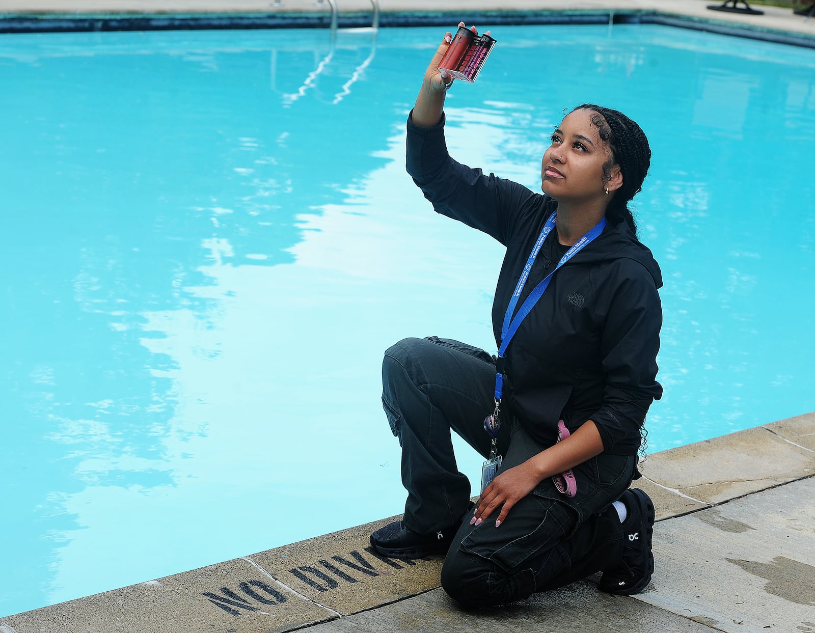 Alana Demmons, an environmental health specialist with Public Health - Dayton & Montgomery County, checks the pool chemicals Wednesday, May 22, 2024, at a private pool at the Miami Valley Hunt and Polo Club in Dayton ahead of Memorial Day weekend. There are approximately 300 pools in Montgomery County that the health department checks, and many pools are getting ready to open for the summer. MARSHALL GORBY\STAFF