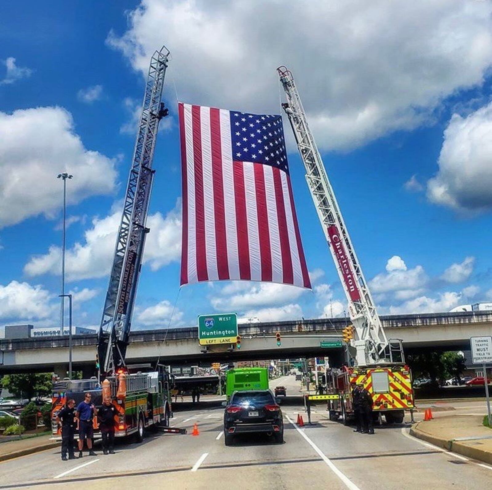 During last Friday’s citywide salute to fallen Charleston W.V. firefighter Jason Cuffee, the firetruck carrying his flag-draped coffin passed beneath a huge American flag held aloft lot by two ladder trucks on Quarrier Street. Hundreds of firefighters and medics from across the state – many in dress uniforms – showed up at the memorial ceremony held at the Charleston Coliseum and Convention Center. Many basketball players and coaches also were there, including a sizeable contingent from Cedarville University where Cuffee was a standout 6-foot-4 guard for three seasons. Cuffee died unexpectedly while in duty July 19. CONTRIBUTED