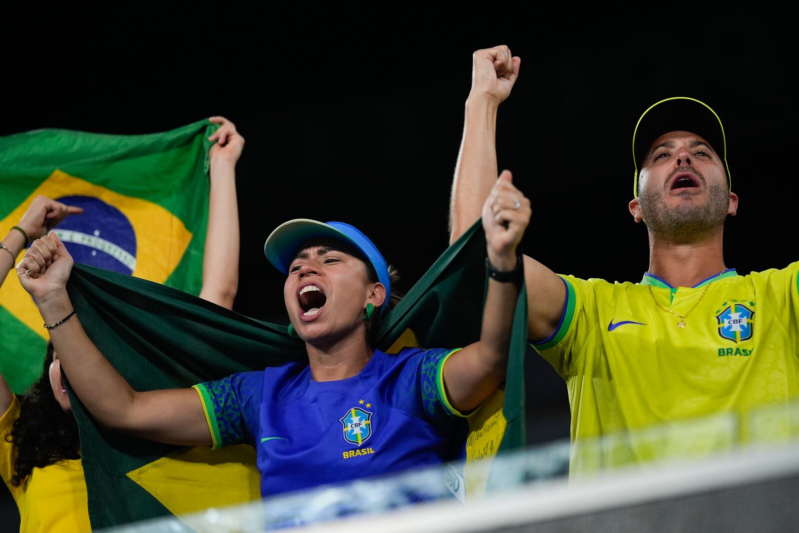 Supporters of Joao Fonseca of Brazil react during his first round match against Andrey Rublev of Russia at the Australian Open tennis championship in Melbourne, Australia, Tuesday, Jan. 14, 2025. (AP Photo/Asanka Brendon Ratnayake)