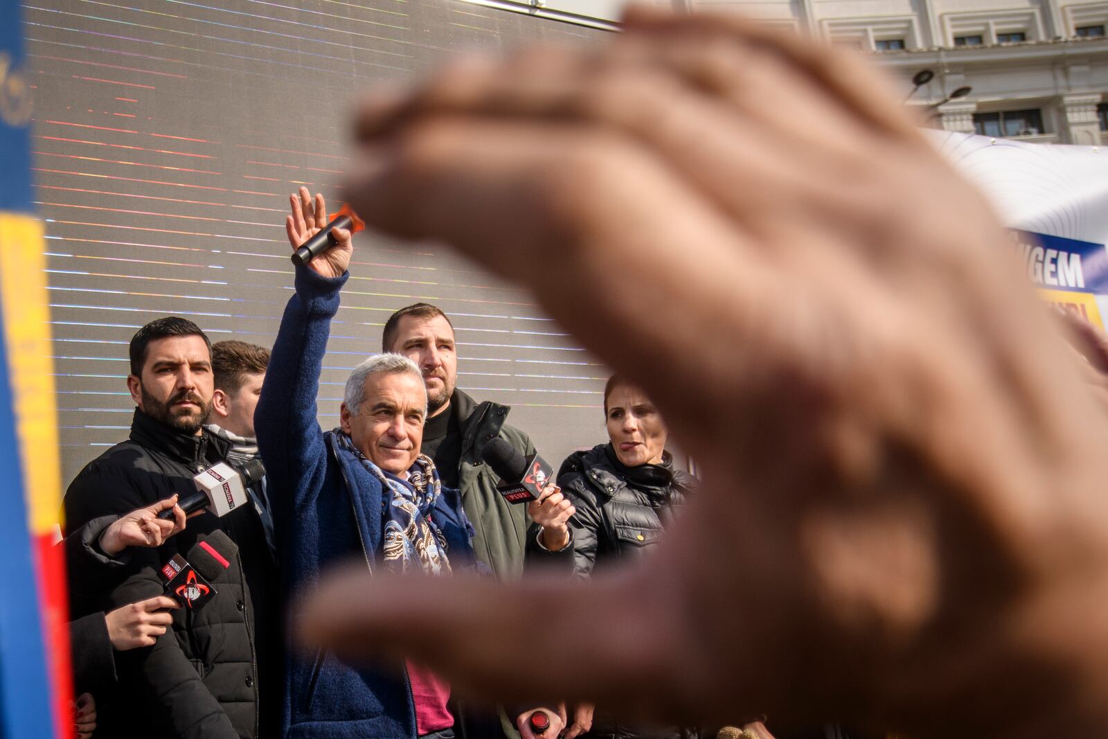 Calin Georgescu, the winner of Romania's first round of presidential election, annulled by the Constitutional Court, waves to supporters gathered for a protest outside the Romanian parliament in Bucharest, Romania, Saturday, Feb. 22, 2025. (AP Photo/Alexandru Dobre)