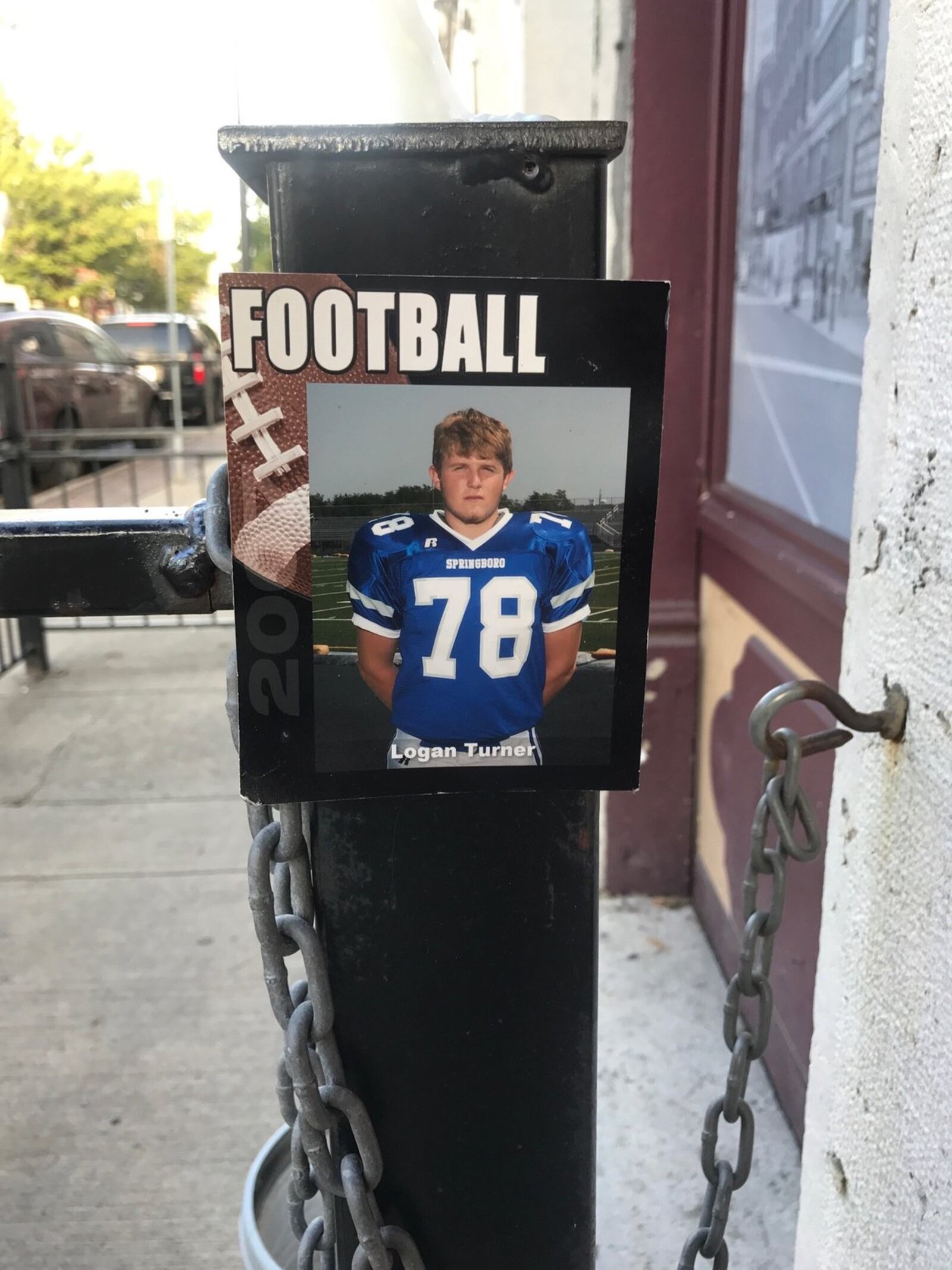 Photo of Logan Turner in his No. 78 Springboro High football jersey taped Sunday by his dad, Mike, to the iron fencing near the entrance to Ned Peppers bar. Logan was the starting 245 pound right tackle for the Panthers in the 2007 season, his senior year. He became a popular and successful figure in Springboro since graduation. Tom Archdeacon/STAFF