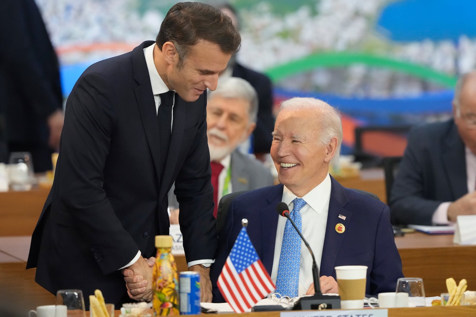 U.S. President Joe Biden, right, and France's President Emmanuel Macron shake hands during the G20 Summit leaders meeting in Rio de Janeiro, Monday, Nov. 18, 2024. (AP Photo/Eraldo Peres)